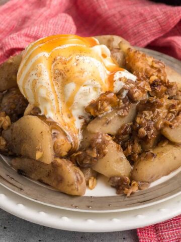Pear Crisp is a delicious baked dessert with a sweet pear filling and a crunchy oat and walnut crumble topping.