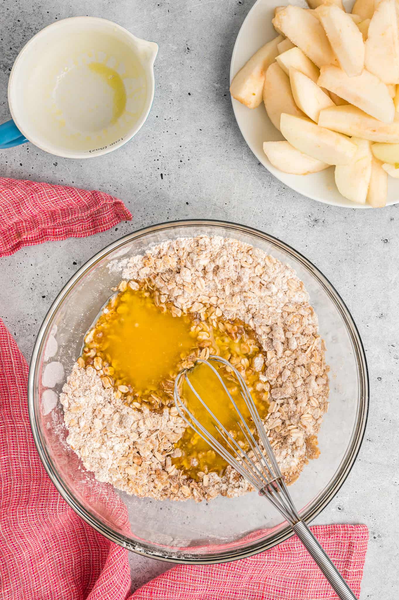 melted butter added to bowl with flour, oat and brown sugar mixture