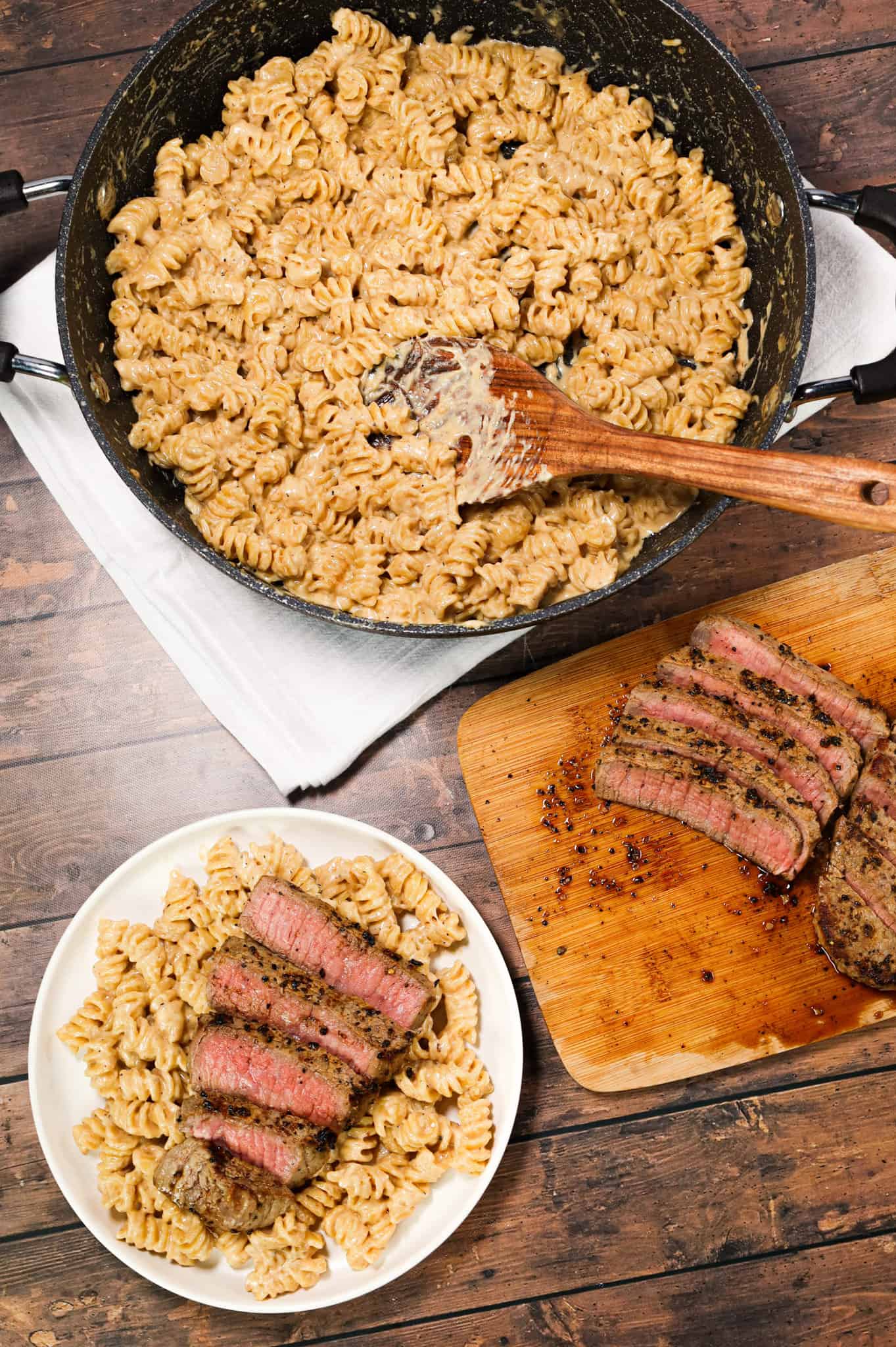 Steak Alfredo is an easy dinner recipe with creamy garlic parmesan pasta topped with tender slices of eye of round steak.