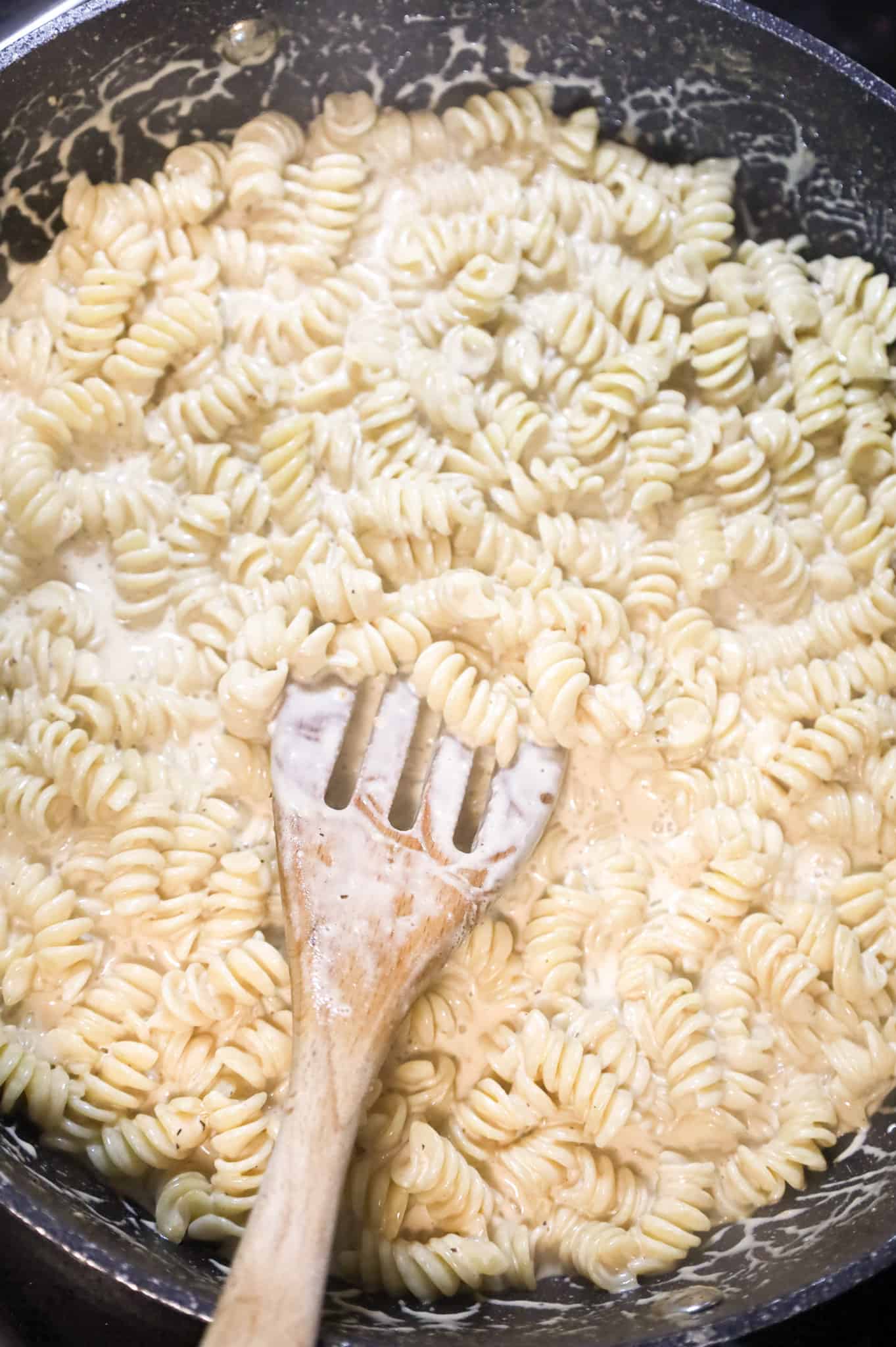 rotini pasta in a creamy parmesan sauce in a skillet