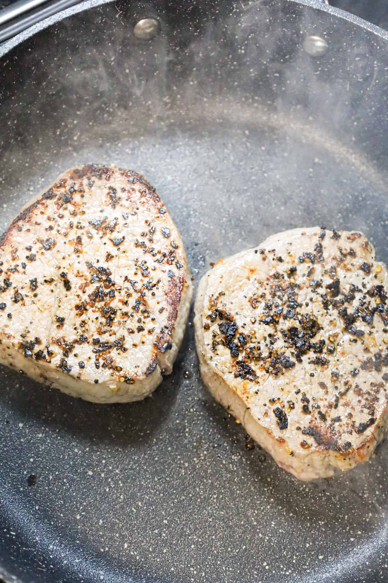 eye of round steaks cooking in a skillet