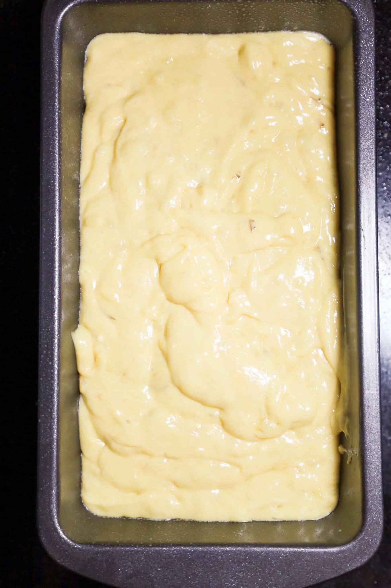 banana bread batter in a loaf pan