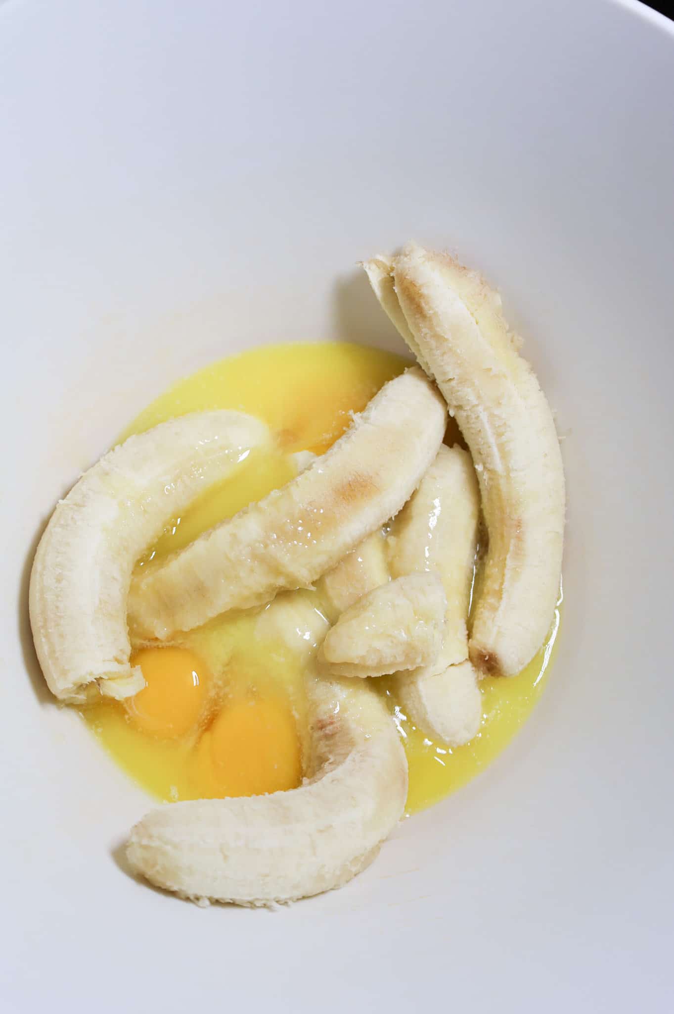 melted butter, eggs and ripe bananas in a mixing bowl