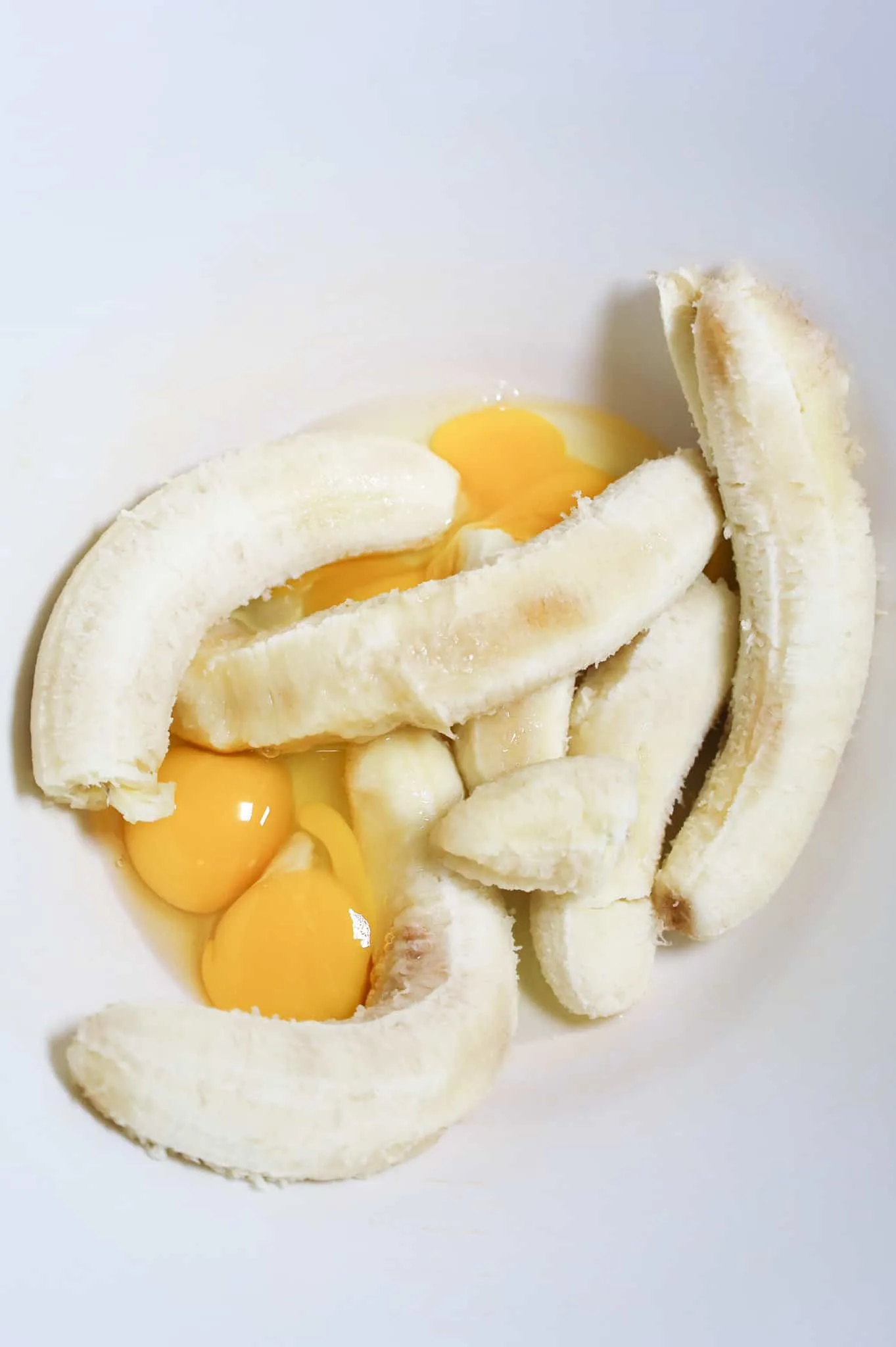 eggs and ripe bananas in a mixing bowl