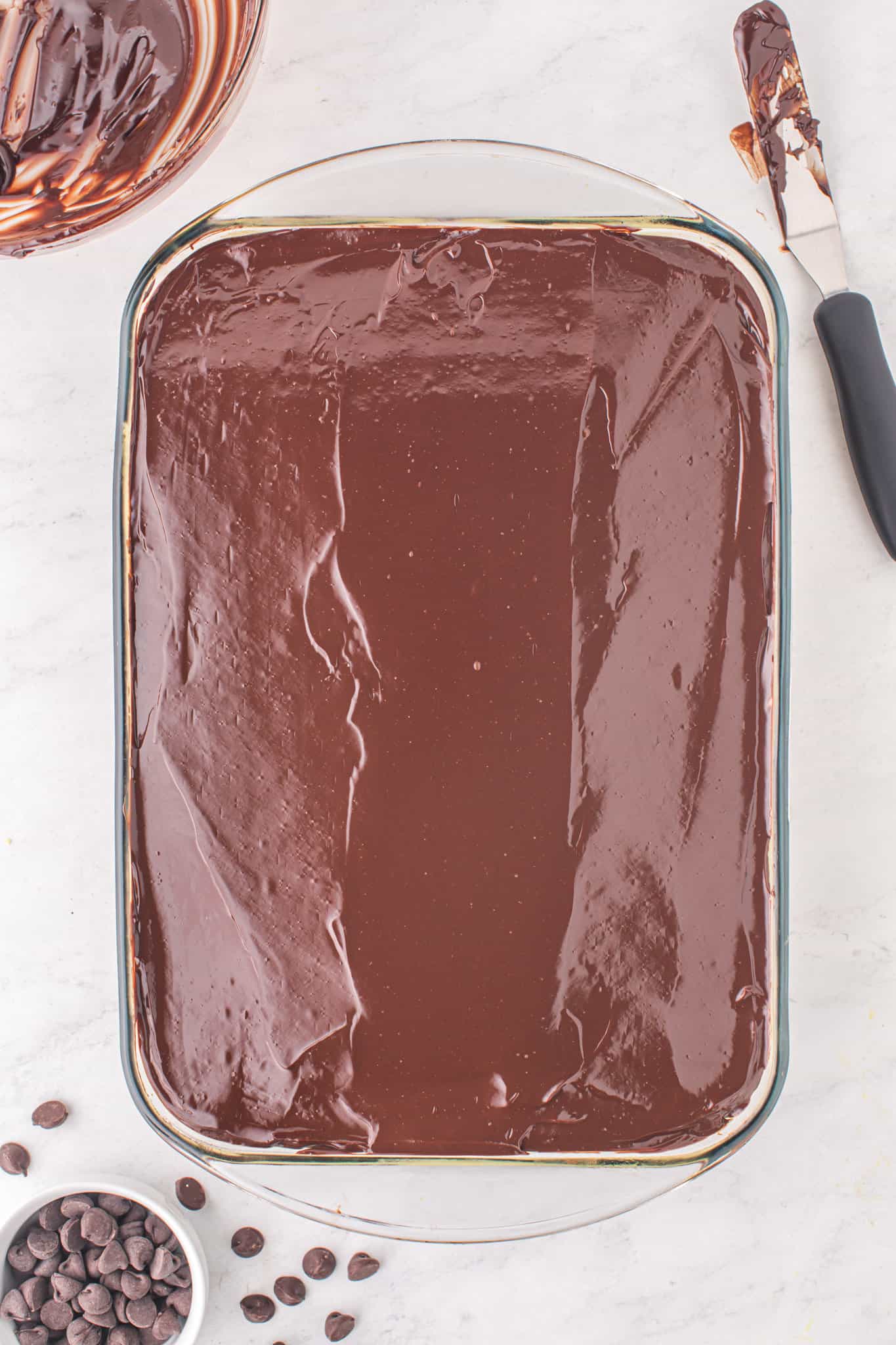 melted chocolate spread over cake in a baking dish