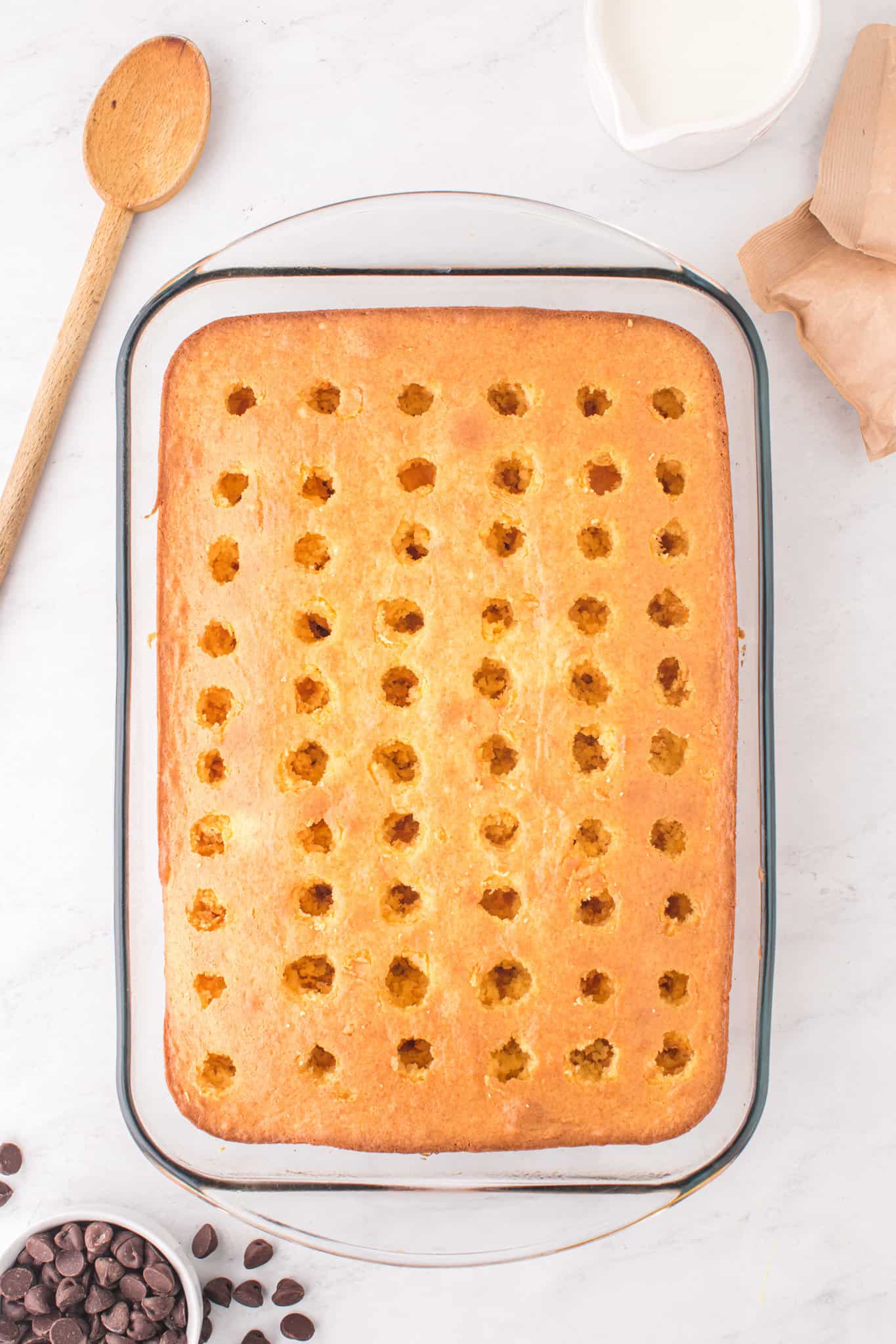 hole poked in a cake in a baking dish