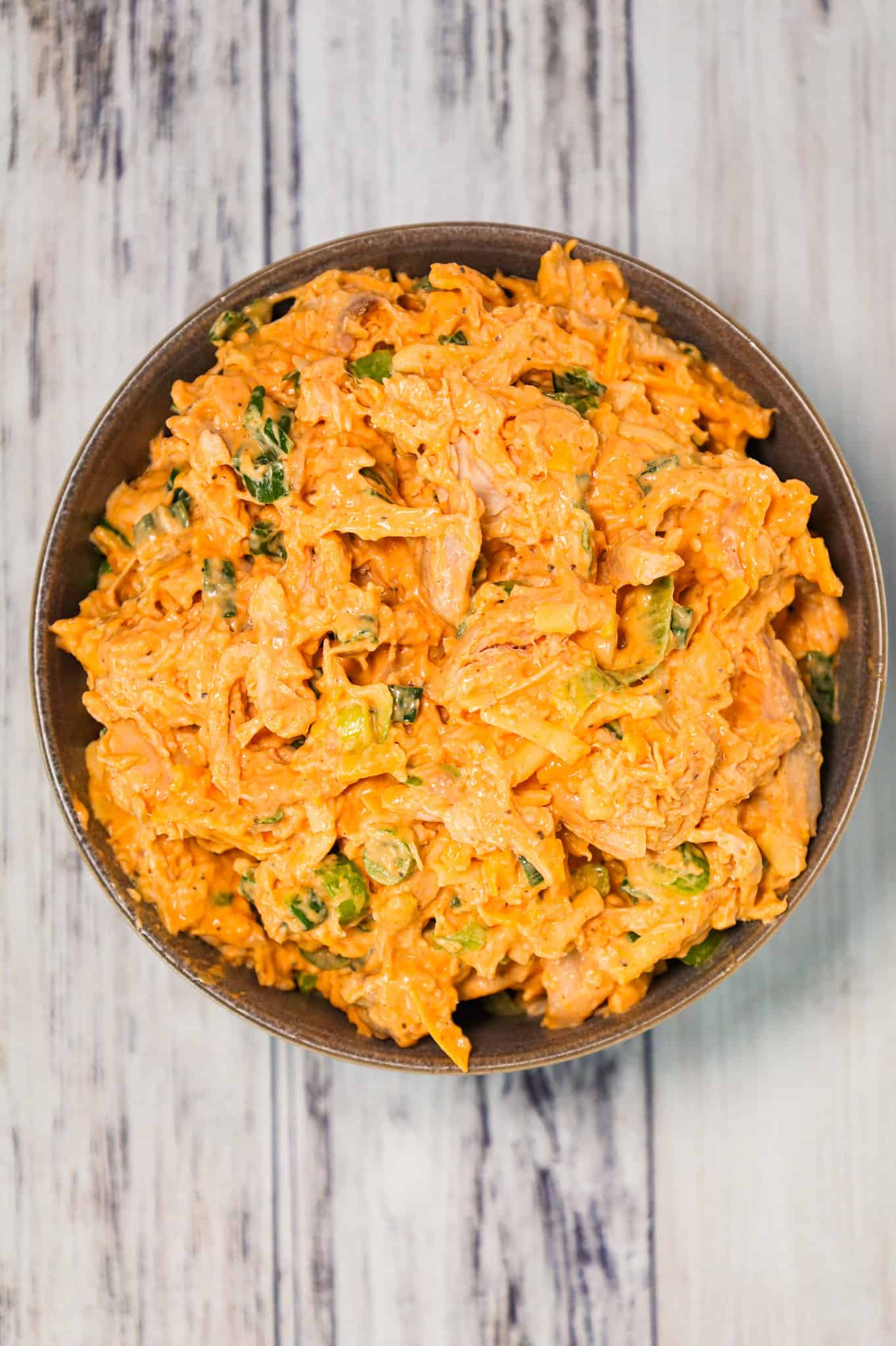 Buffalo Chicken Salad is a delicious recipe using rotisserie chicken, chopped green onions and shredded cheddar cheese all tossed in mayo, Buffalo sauce and ranch dressing.