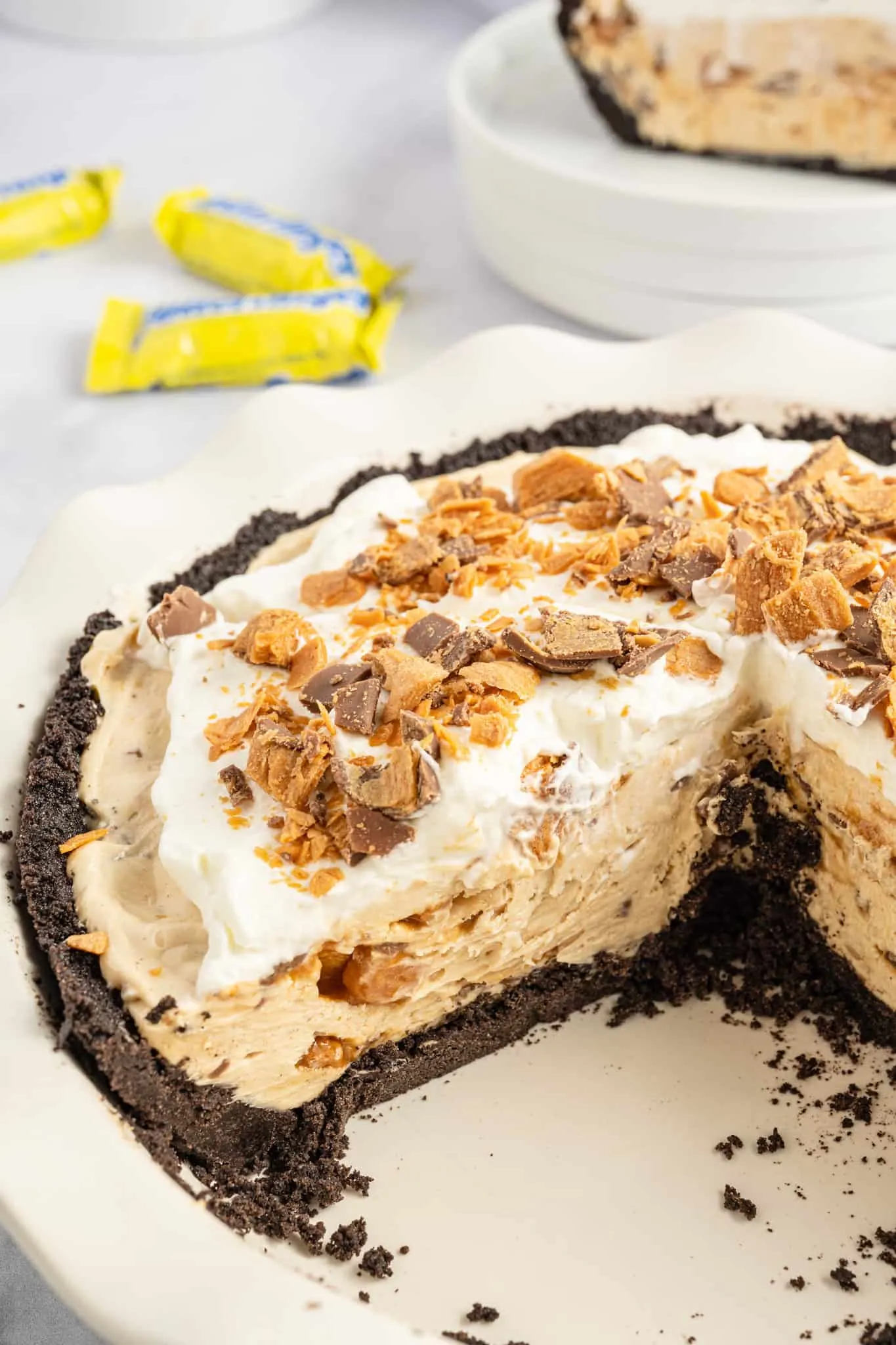 Butterfinger Pie is an easy no bake dessert recipe with an Oreo crust and a creamy peanut butter filling loaded with crumbled Butterfinger candy bars.