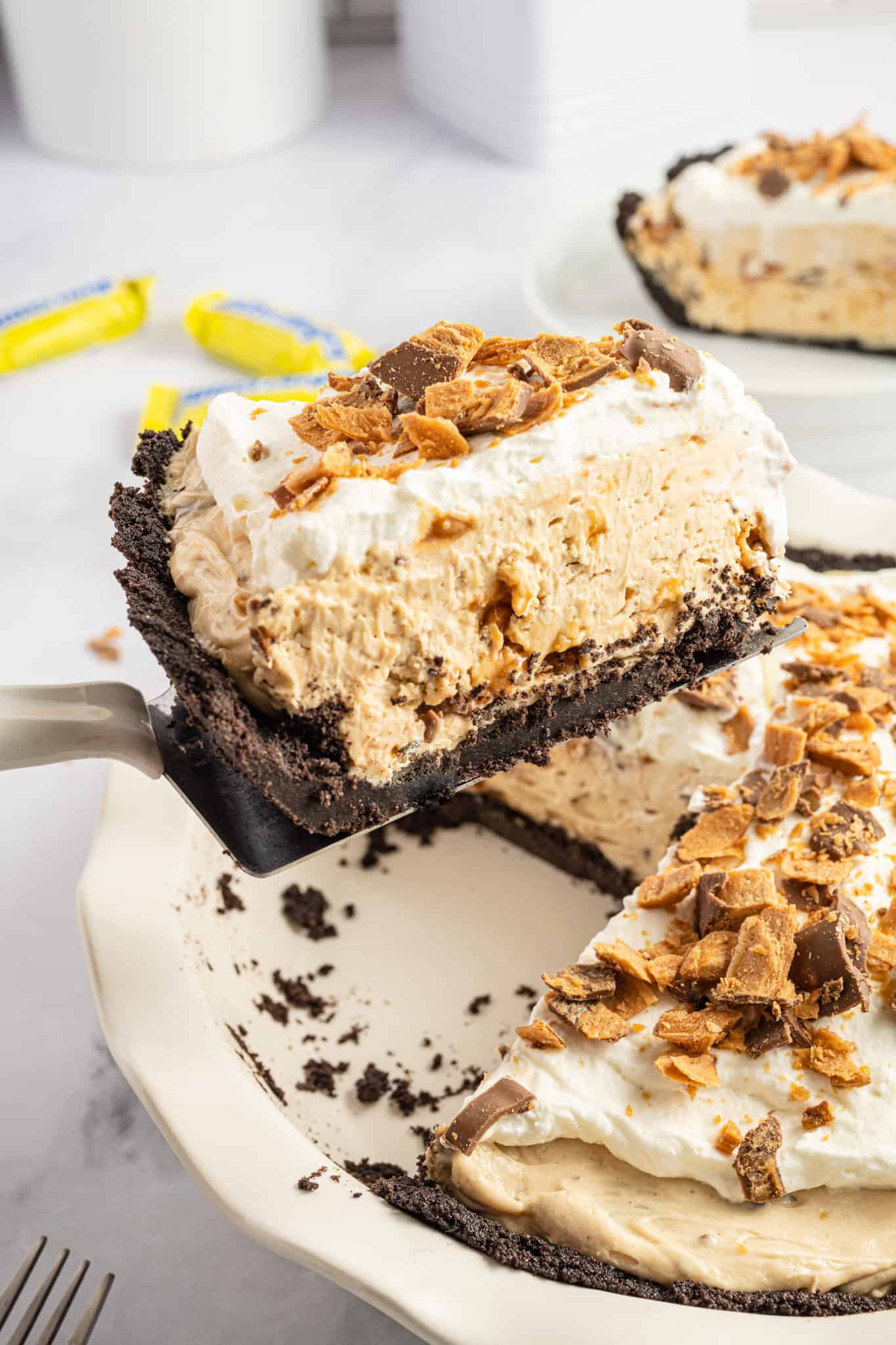 Butterfinger Pie is an easy no bake dessert recipe with an Oreo crust and a creamy peanut butter filling loaded with crumbled Butterfinger candy bars.