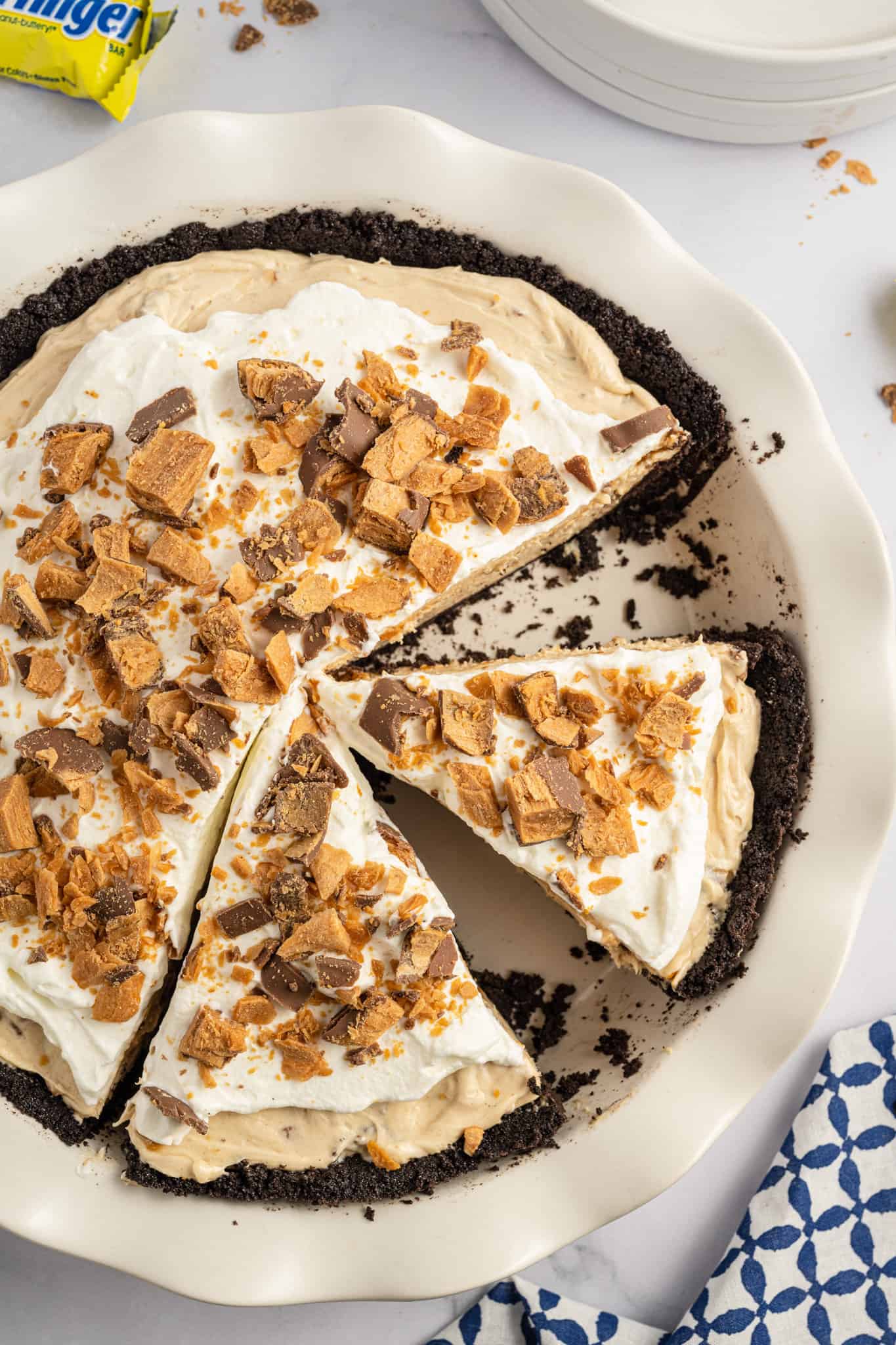 Butterfinger Pie is an easy no bake dessert recipe with an Oreo crust and a creamy peanut butter filling loaded with crumbled Butterfinger candy bars.