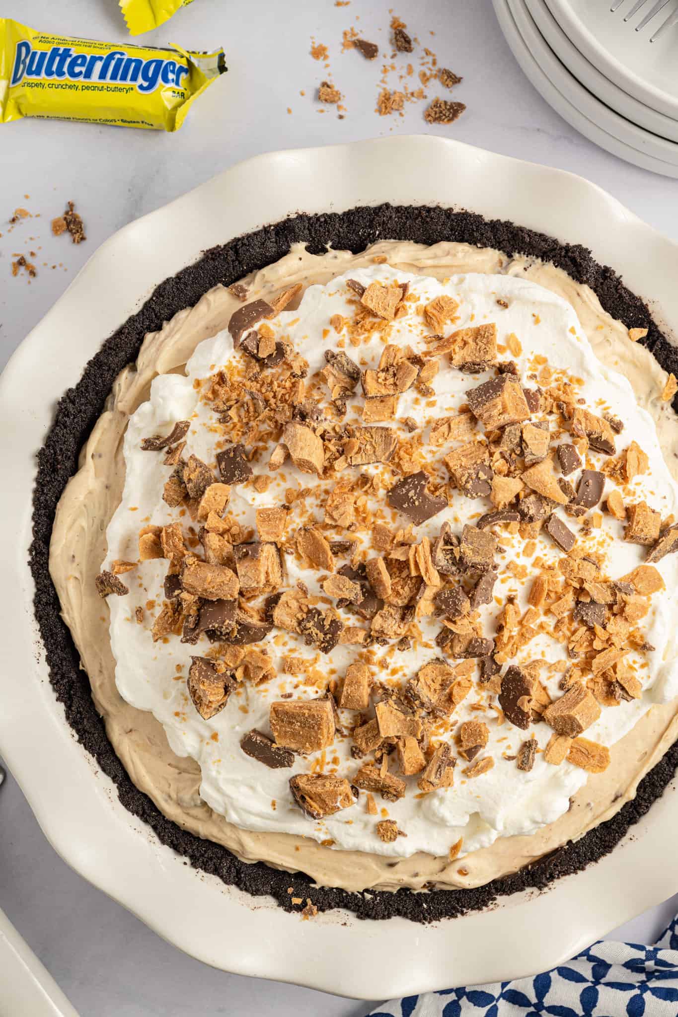 Butterfinger Pie is an easy no bake dessert recipe with an Oreo crust and a creamy peanut butter filling loaded with crumbled Butterfinger candy bars.