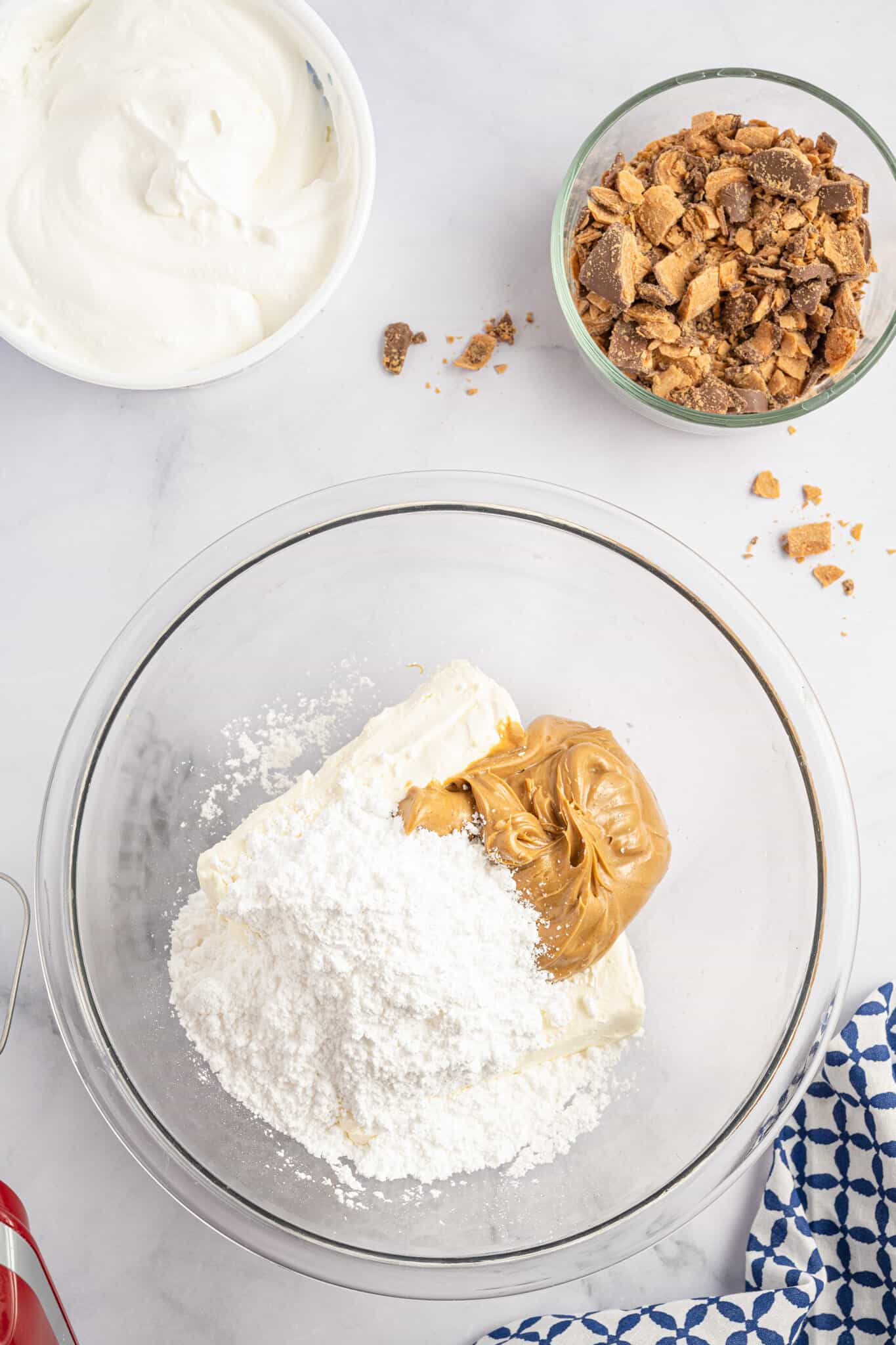 confectioner's sugar, peanut butter and cream cheese in a mixing bowl