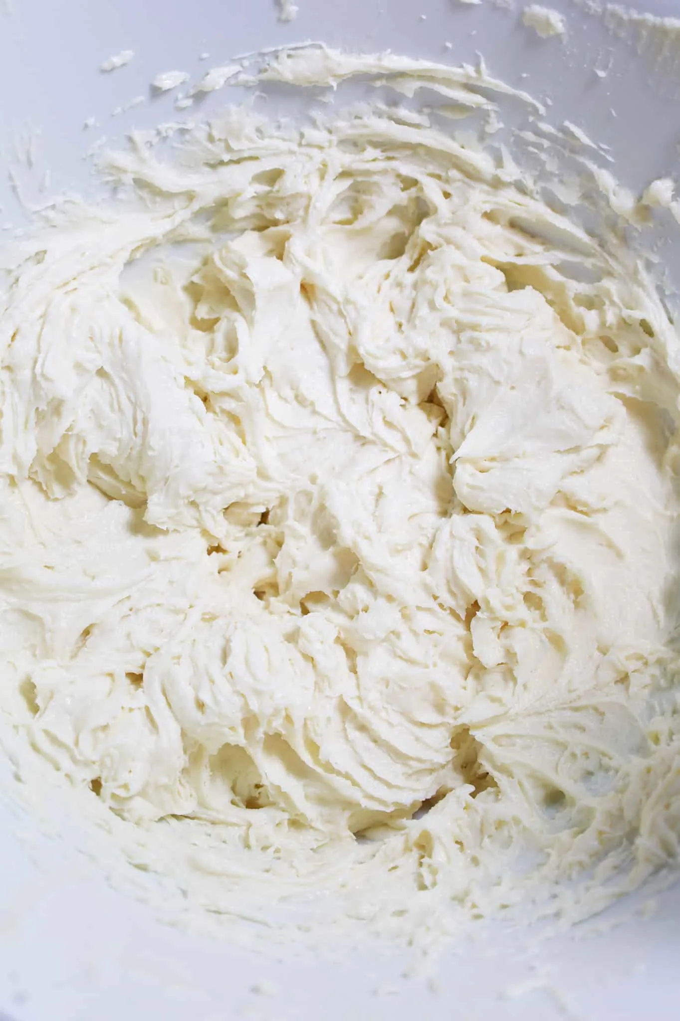ricotta cheese, cream cheese and confectioner's sugar mixture in a mixing bowl