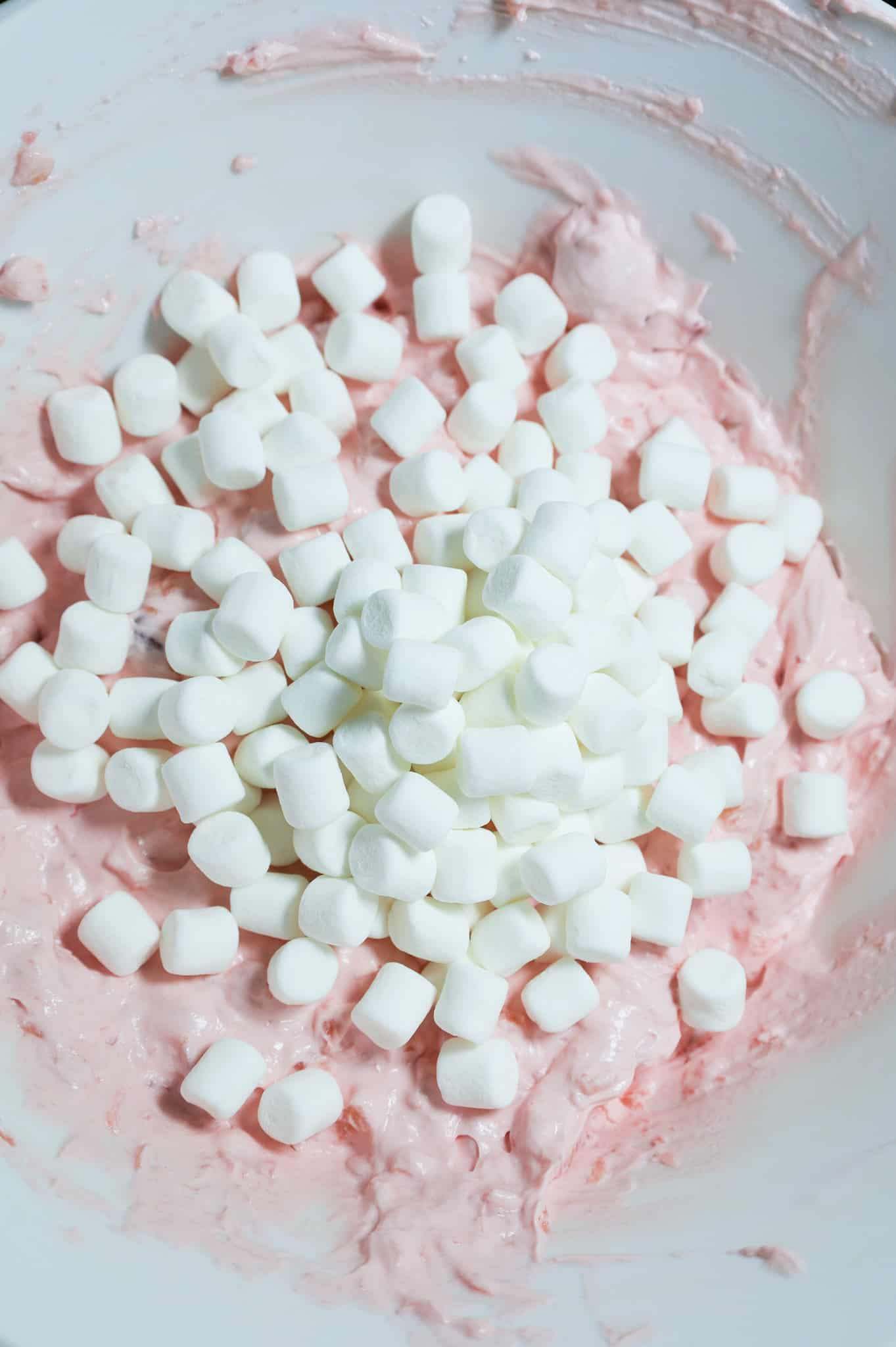 mini marshmallows added to cherry fluff mixture in a mixing bowl