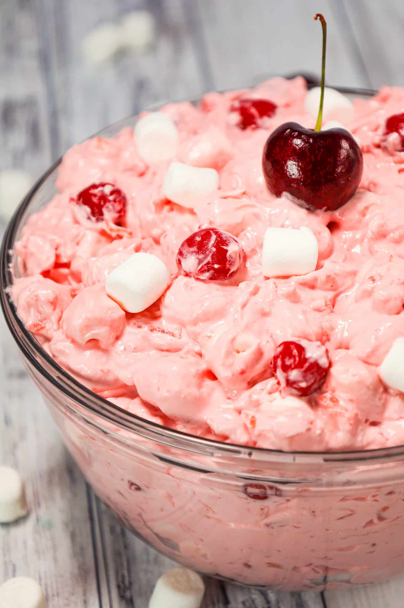 Cherry Fluff is an easy no bake dessert or side dish recipe made with cherry pie filling, crushed pineapple, instant vanilla pudding mix and Cool Whip and loaded with mini marshmallows.