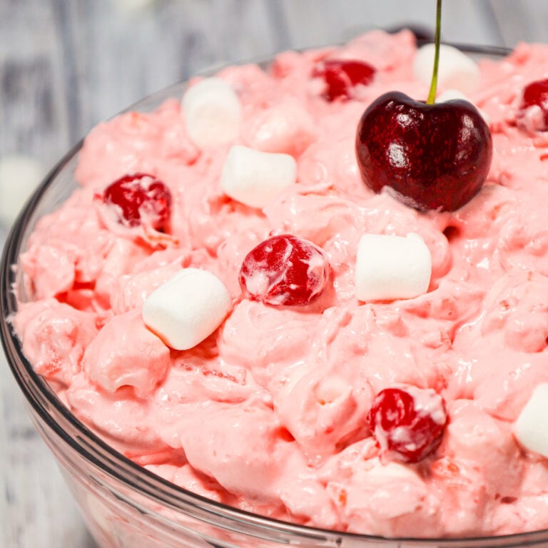 Cherry Fluff is an easy no bake dessert or side dish recipe made with cherry pie filling, crushed pineapple, instant vanilla pudding mix and Cool Whip and loaded with mini marshmallows.