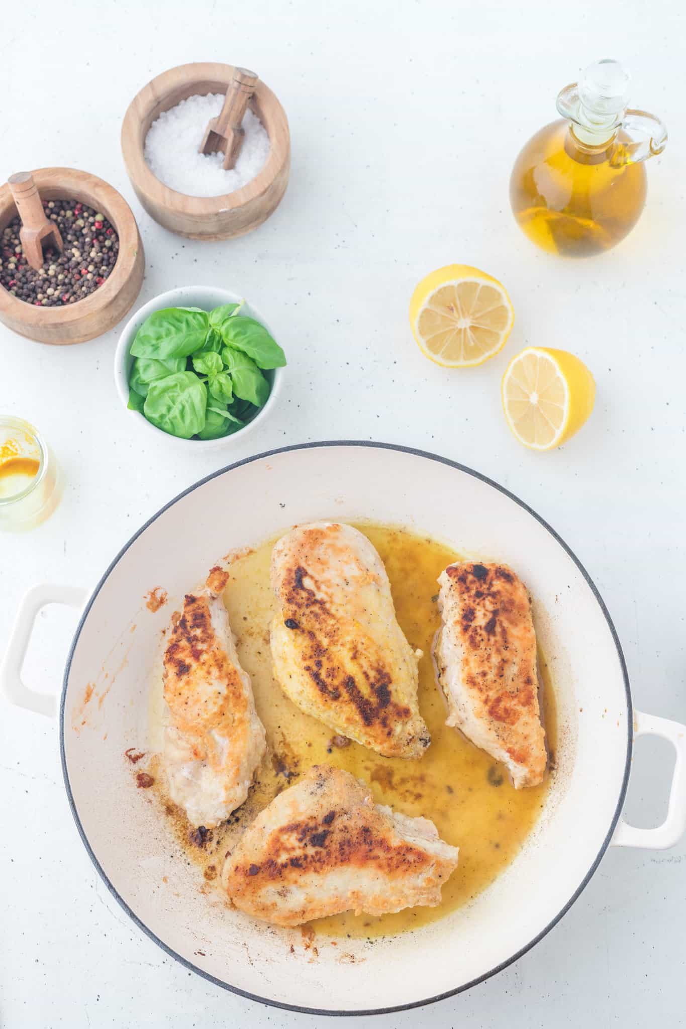 cooked chicken breasts in lemon sauce in a skillet