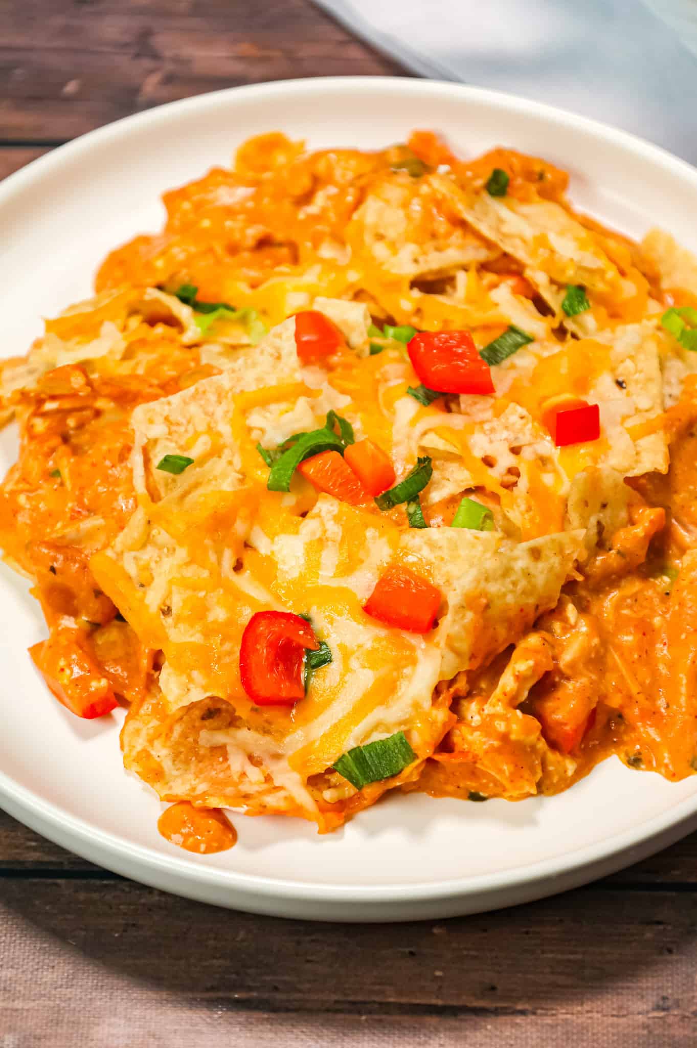 Chicken Taco Casserole is an easy weeknight dinner recipe using rotisserie chicken tossed with, cream cheese, cream of chicken soup, cheddar soup and salsa all topped with crumbled tortilla chips and cheese.