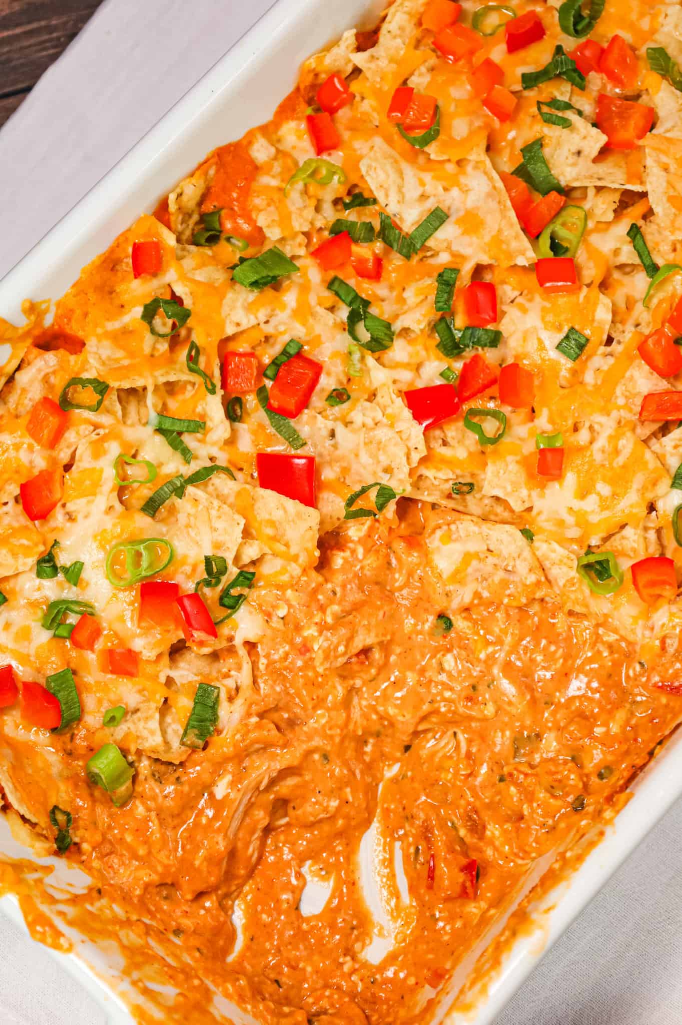 Chicken Taco Casserole is an easy weeknight dinner recipe using rotisserie chicken tossed with, cream cheese, cream of chicken soup, cheddar soup and salsa all topped with crumbled tortilla chips and cheese.