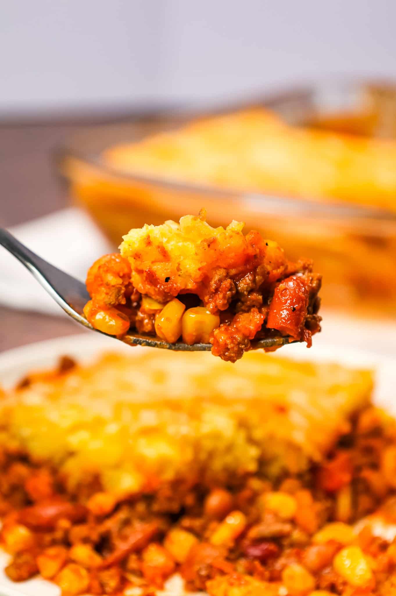 Chili Cornbread Casserole is an easy ground beef dinner recipe loaded with salsa, mixed beans, corn, chili seasoning and topped with cornbread and shredded cheese.