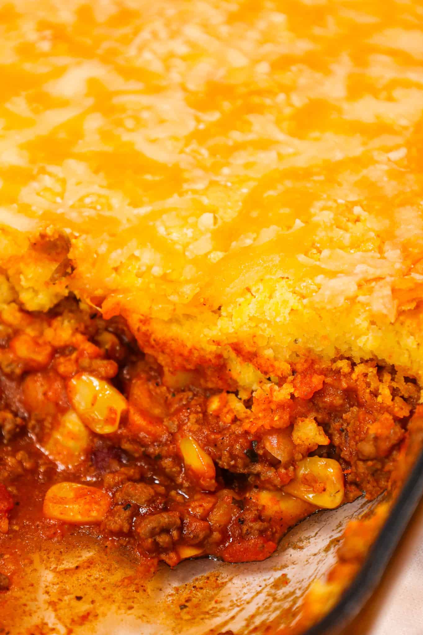 Chili Cornbread Casserole is an easy ground beef dinner recipe loaded with salsa, mixed beans, corn, chili seasoning and topped with cornbread and shredded cheese.