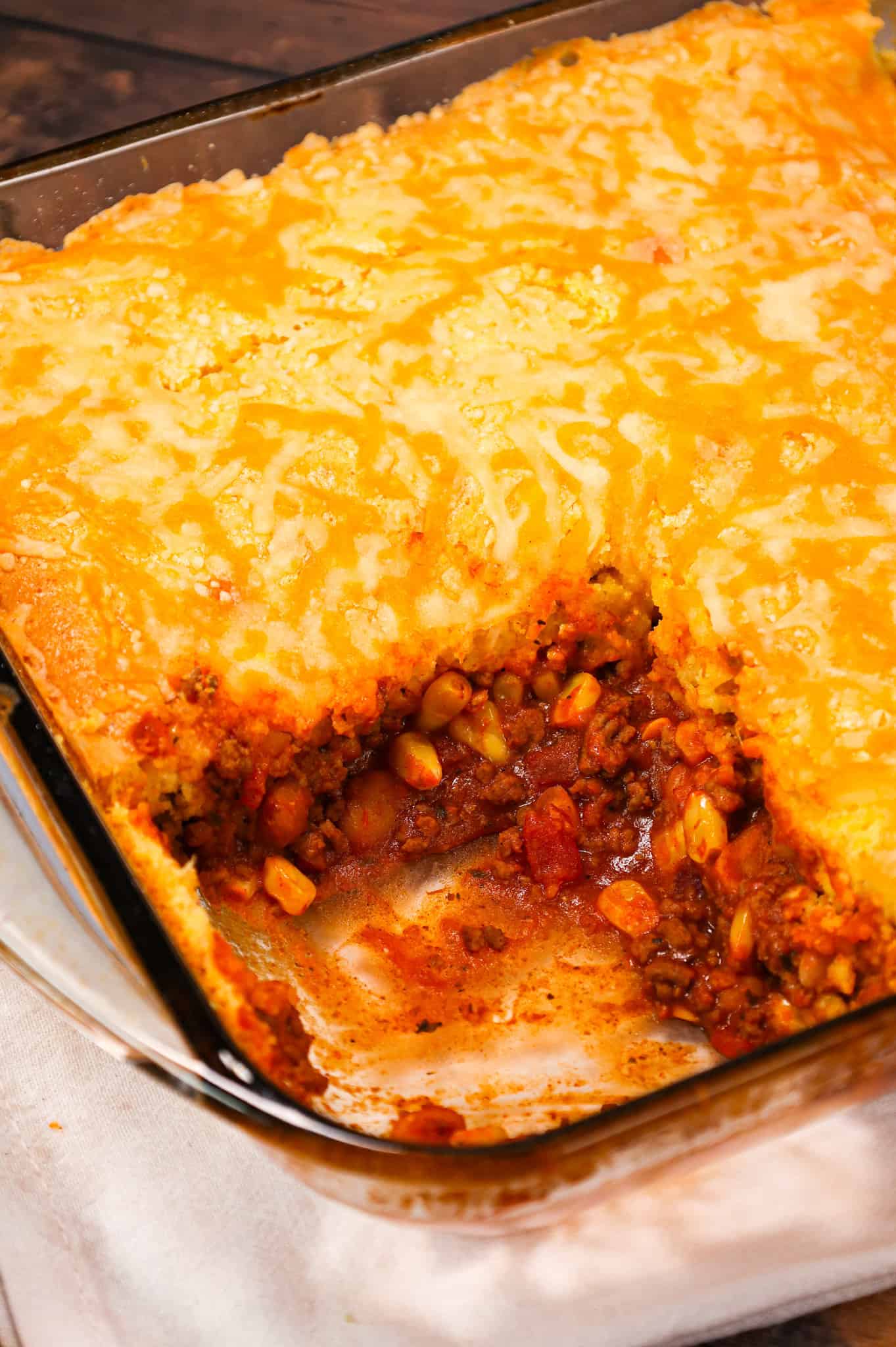 Chili Cornbread Casserole is an easy ground beef dinner recipe loaded with salsa, mixed beans, corn, chili seasoning and topped with cornbread and shredded cheese.