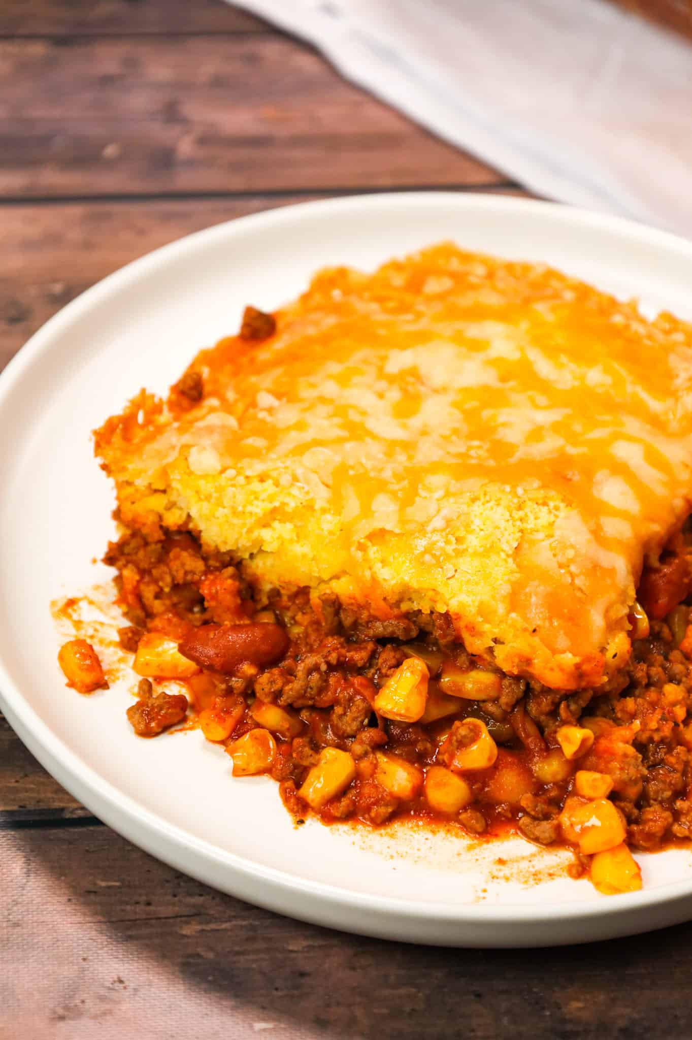 Chili Cornbread Casserole is an easy ground beef dinner recipe loaded with salsa, mixed beans, corn, chili seasoning and topped with cornbread and shredded cheese.