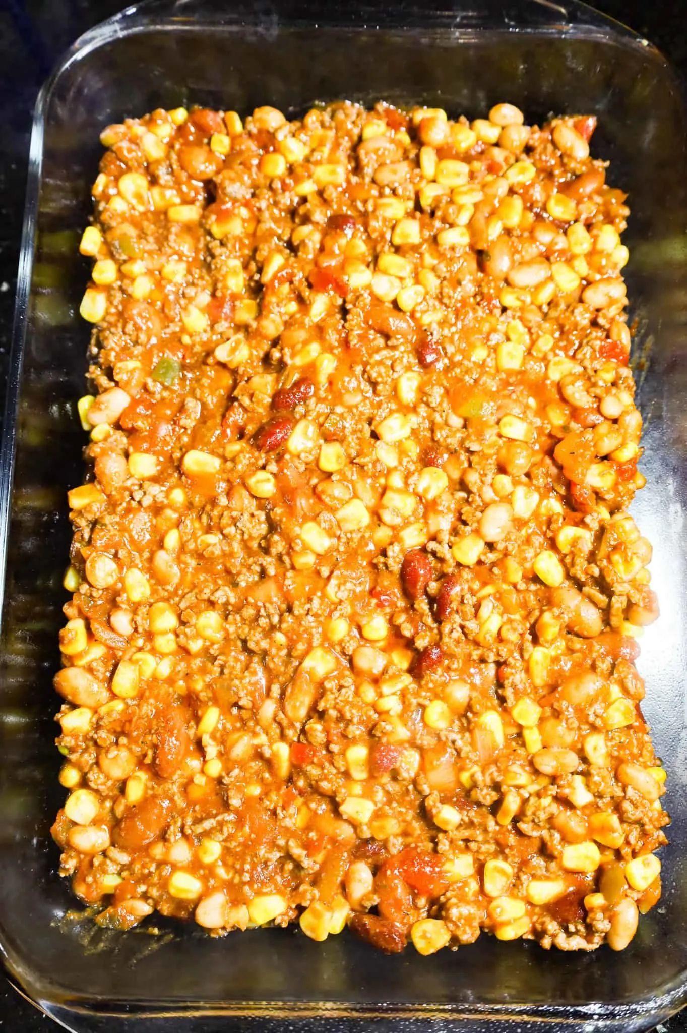 ground beef, corn, bean and salsa mixture in a baking dish