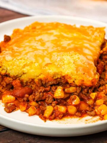 Chili Cornbread Casserole is an easy ground beef dinner recipe loaded with salsa, mixed beans, corn, chili seasoning and topped with cornbread and shredded cheese.