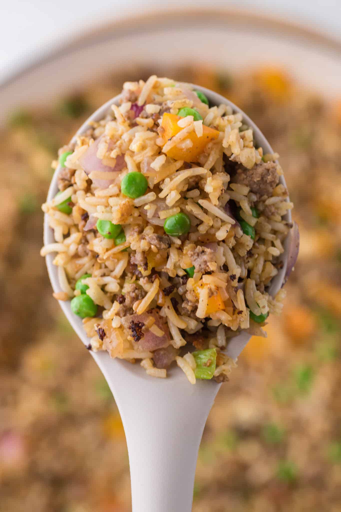 Ground Beef Fried Rice is an easy dinner recipe made with long grain rice and loaded with ground beef, diced bell peppers, peas, sesame seeds and eggs.