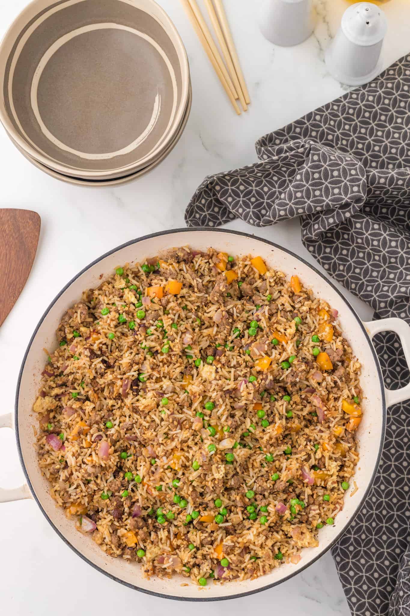 Ground Beef Fried Rice is an easy dinner recipe made with long grain rice and loaded with ground beef, diced bell peppers, peas, sesame seeds and eggs.