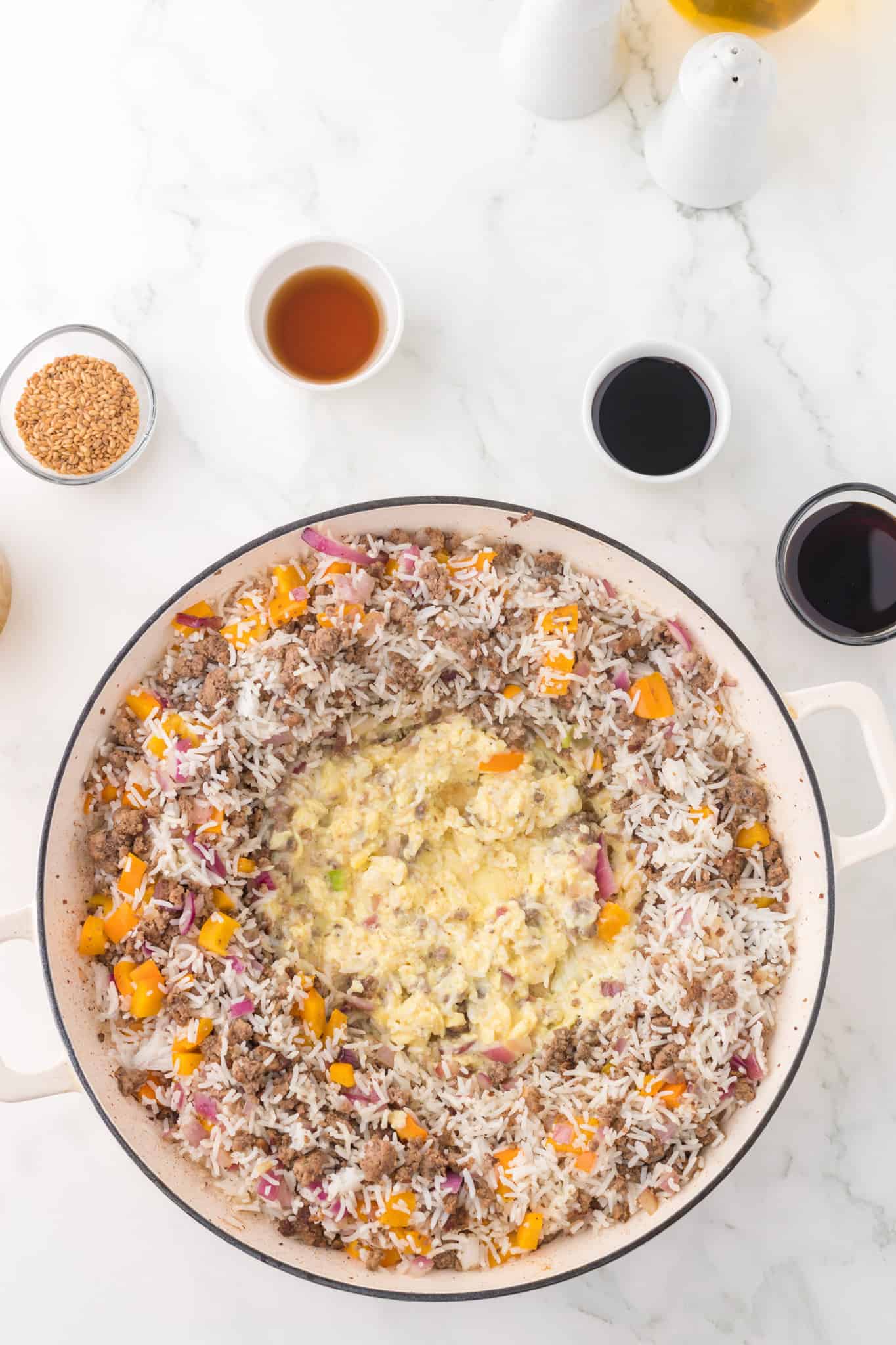 beaten eggs added to skillet with cooked rice and ground beef