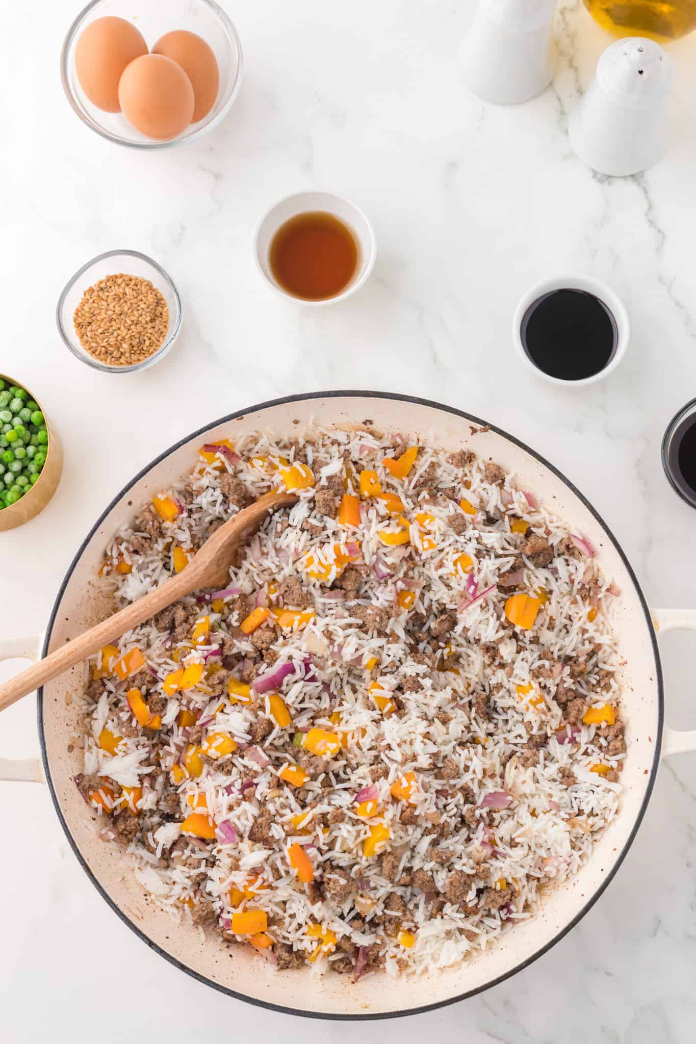 stirring cooked rice, diced peppers, diced onions and cooked ground beef together in a skillet