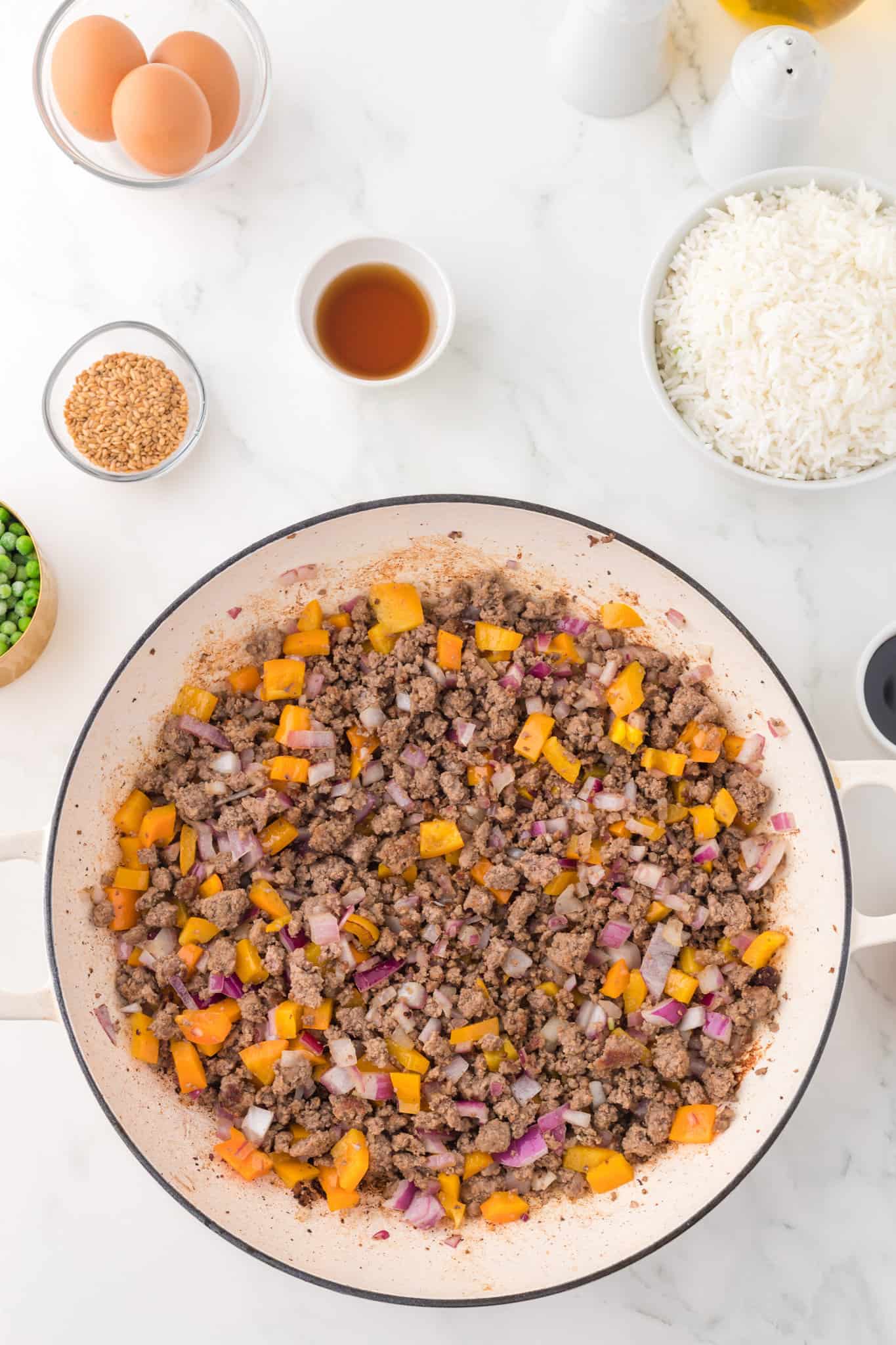 ground beef, diced orange bell peppers and diced onions in a skillet