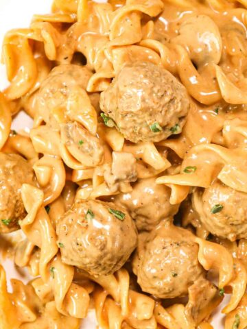 Meatball Stroganoff is an easy dinner recipe with egg noodles, diced onions, sliced mushrooms and store bought meatballs all tossed in a beef gravy and sour cream mixture.