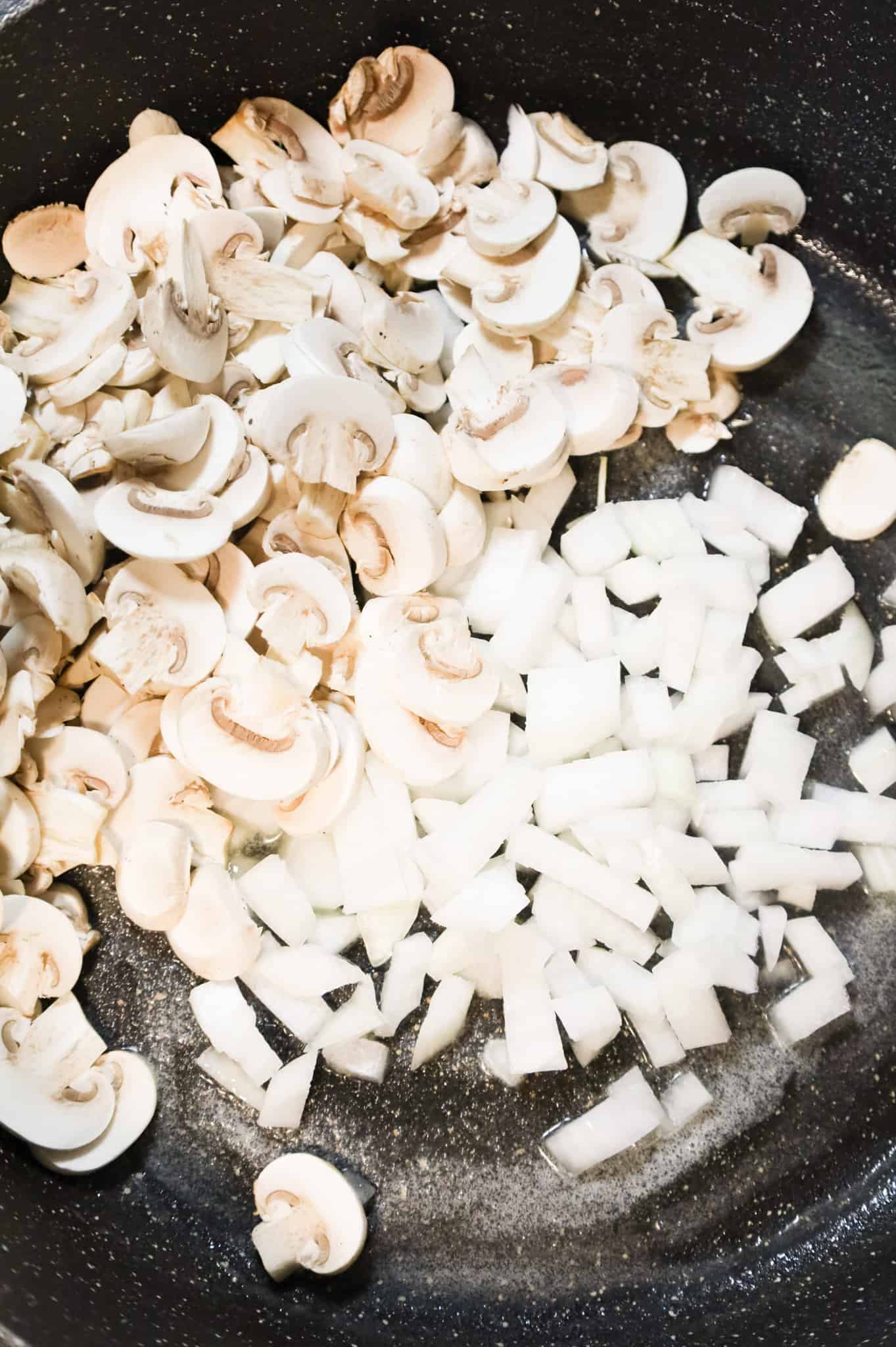 diced onions and sliced mushrooms added to a skillet