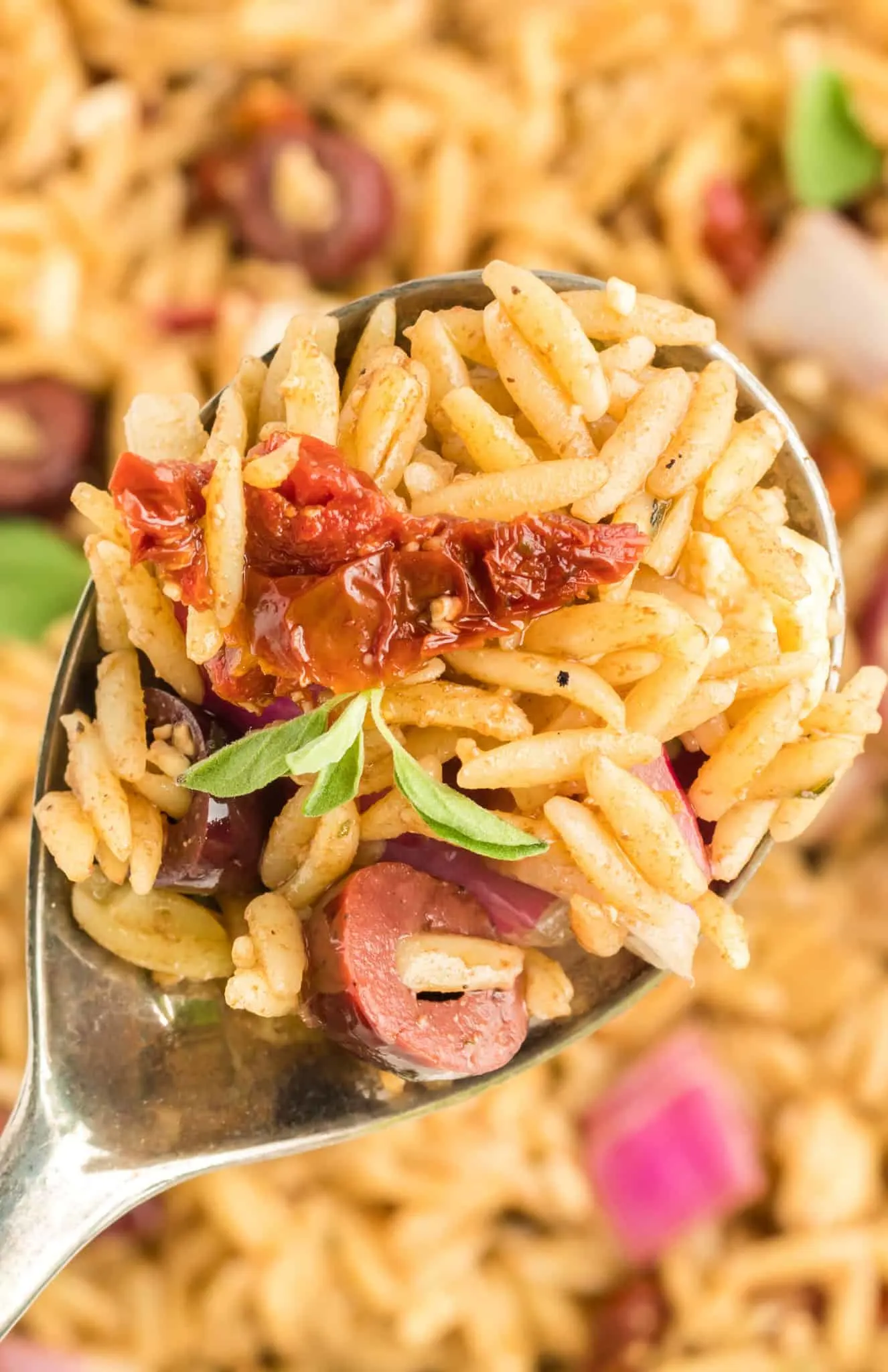 Mediterranean Orzo Pasta Salad is a delicious pasta loaded with sun dried tomatoes, red onions, Kalamata olives and feta cheese all tossed in a honey Dijon balsamic dressing.