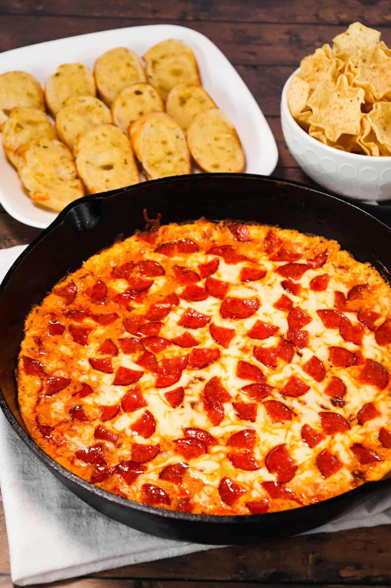 Pepperoni Dip is a delicious hot dip recipe made with cream cheese, ranch dressing, Italian seasoning, pizza sauce, mozzarella cheese, parmesan cheese and chopped pepperoni.