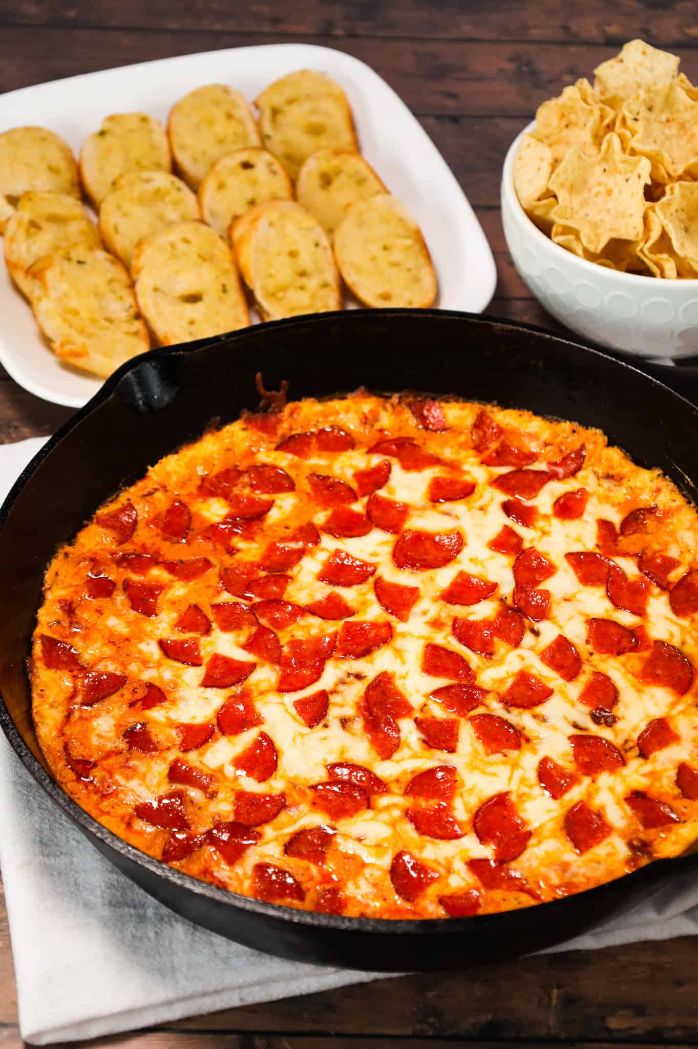 Pepperoni Dip is a delicious hot dip recipe made with cream cheese, ranch dressing, Italian seasoning, pizza sauce, mozzarella cheese, parmesan cheese and chopped pepperoni.