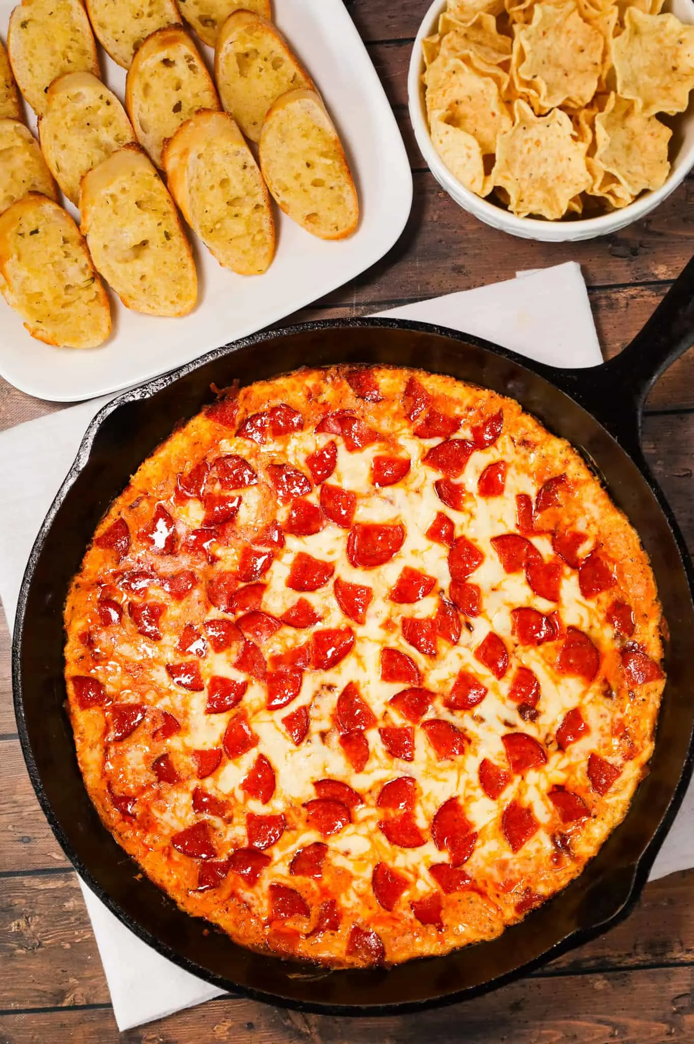 Pepperoni Dip is a delicious hot dip recipe made with cream cheese, ranch dressing, Italian seasoning, pizza sauce, mozzarella cheese, parmesan cheese and chopped pepperoni.