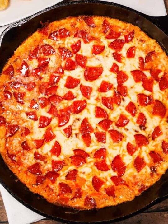 Pepperoni Dip is a delicious hot dip recipe made with cream cheese, ranch dressing, Italian seasoning, pizza sauce, mozzarella cheese, parmesan cheese and chopped pepperoni.
