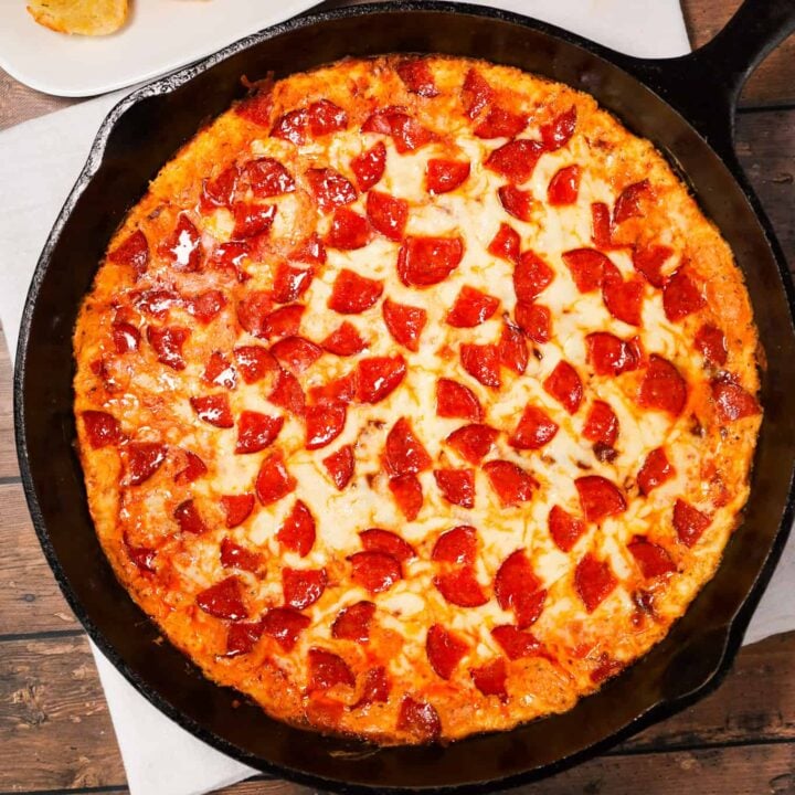 Pepperoni Dip is a delicious hot dip recipe made with cream cheese, ranch dressing, Italian seasoning, pizza sauce, mozzarella cheese, parmesan cheese and chopped pepperoni.