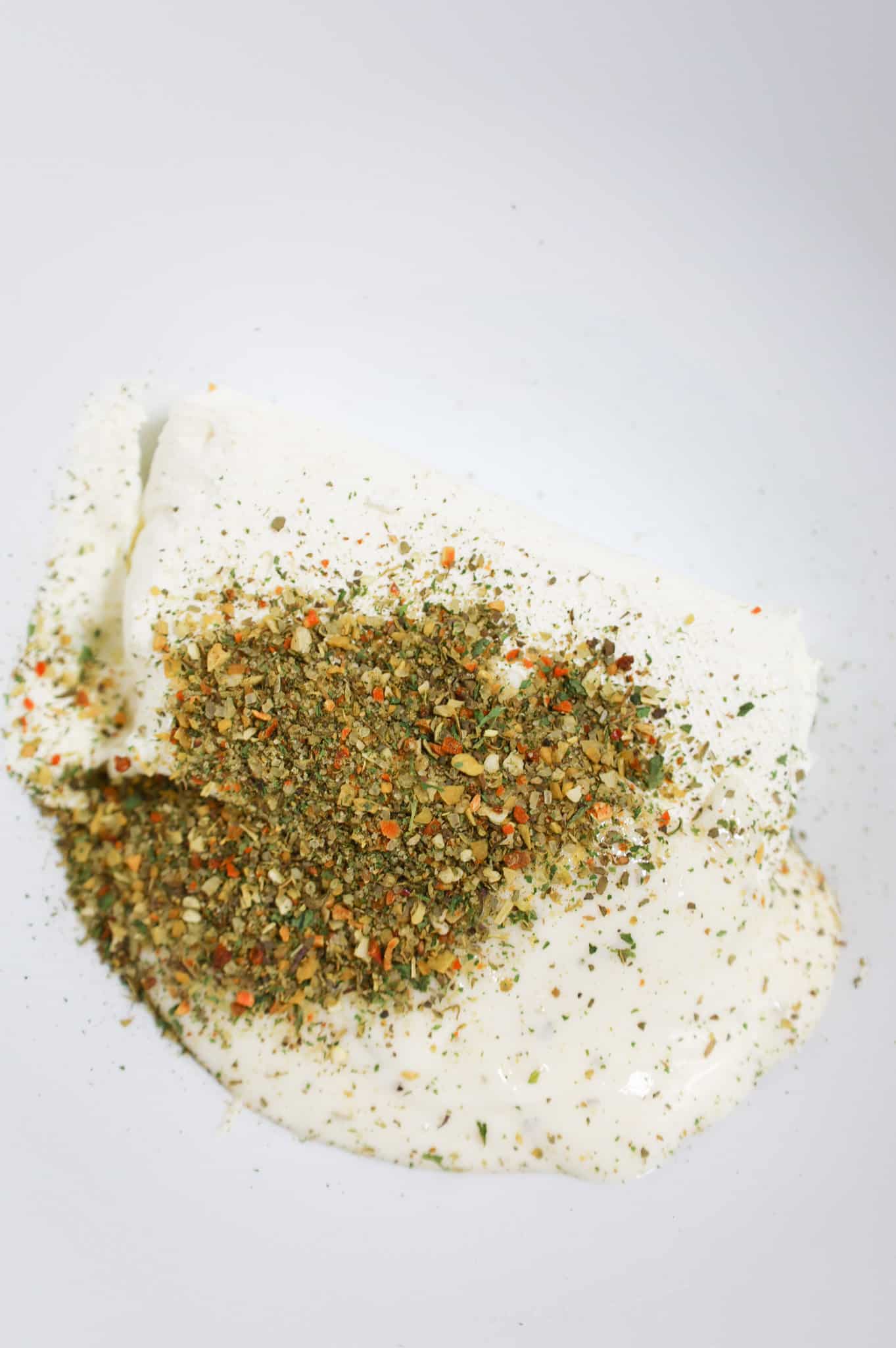 Italian seasoning, ranch dressing and softened cream cheese in a mixing bowl