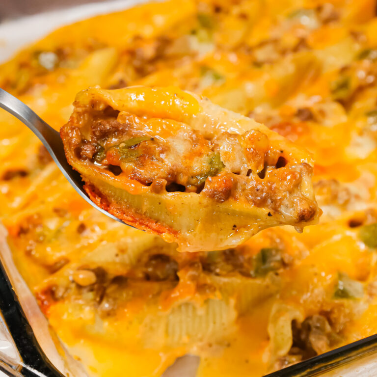 Philly Cheese Steak Stuffed Shells are a hearty pasta recipe loaded with ground beef, diced onions, green peppers, brown gravy mix, cheddar soup and shredded cheddar cheese.