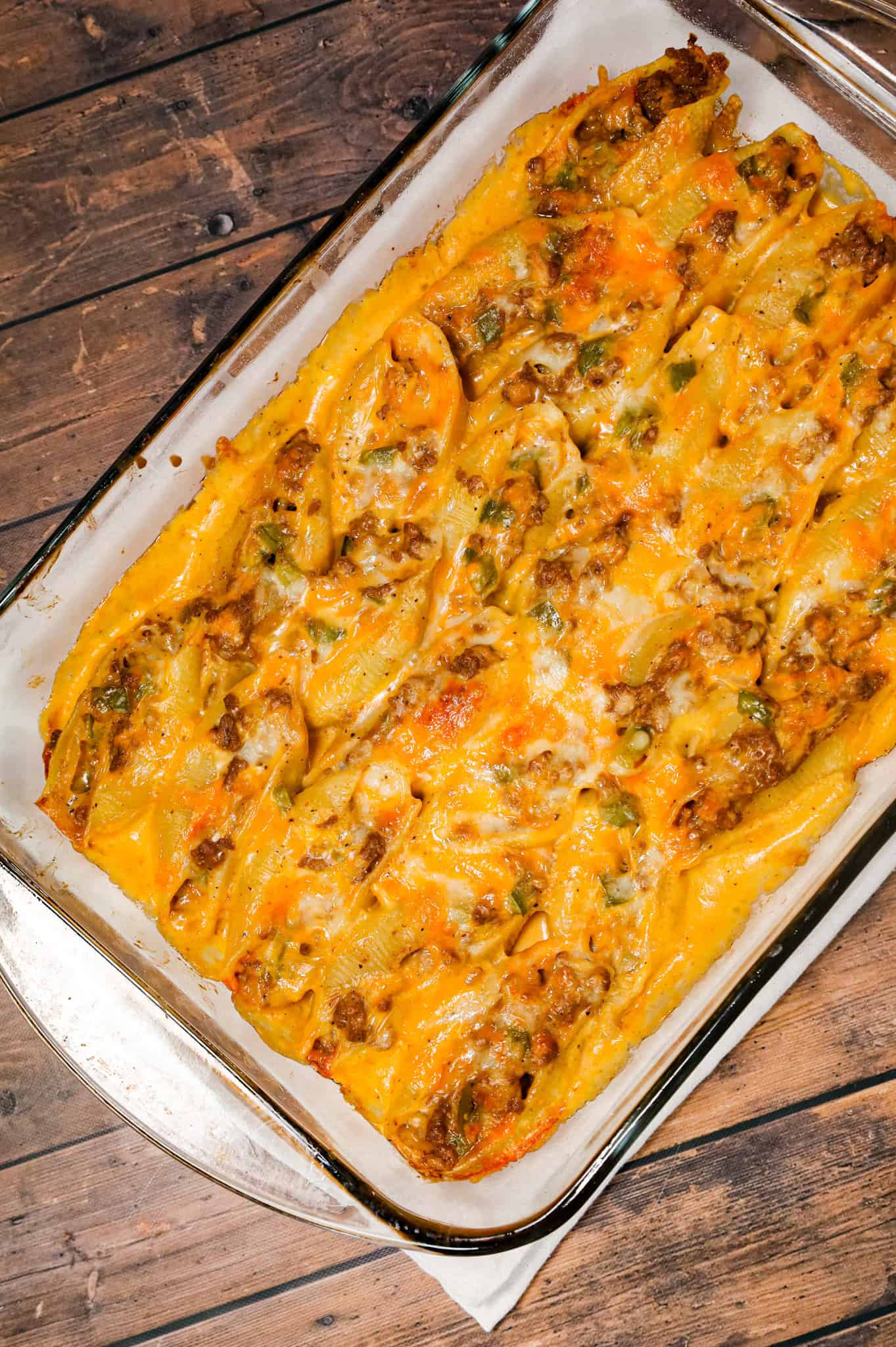 Philly Cheese Steak Stuffed Shells are a hearty pasta recipe loaded with ground beef, diced onions, green peppers, brown gravy mix, cheddar soup and shredded cheddar cheese.