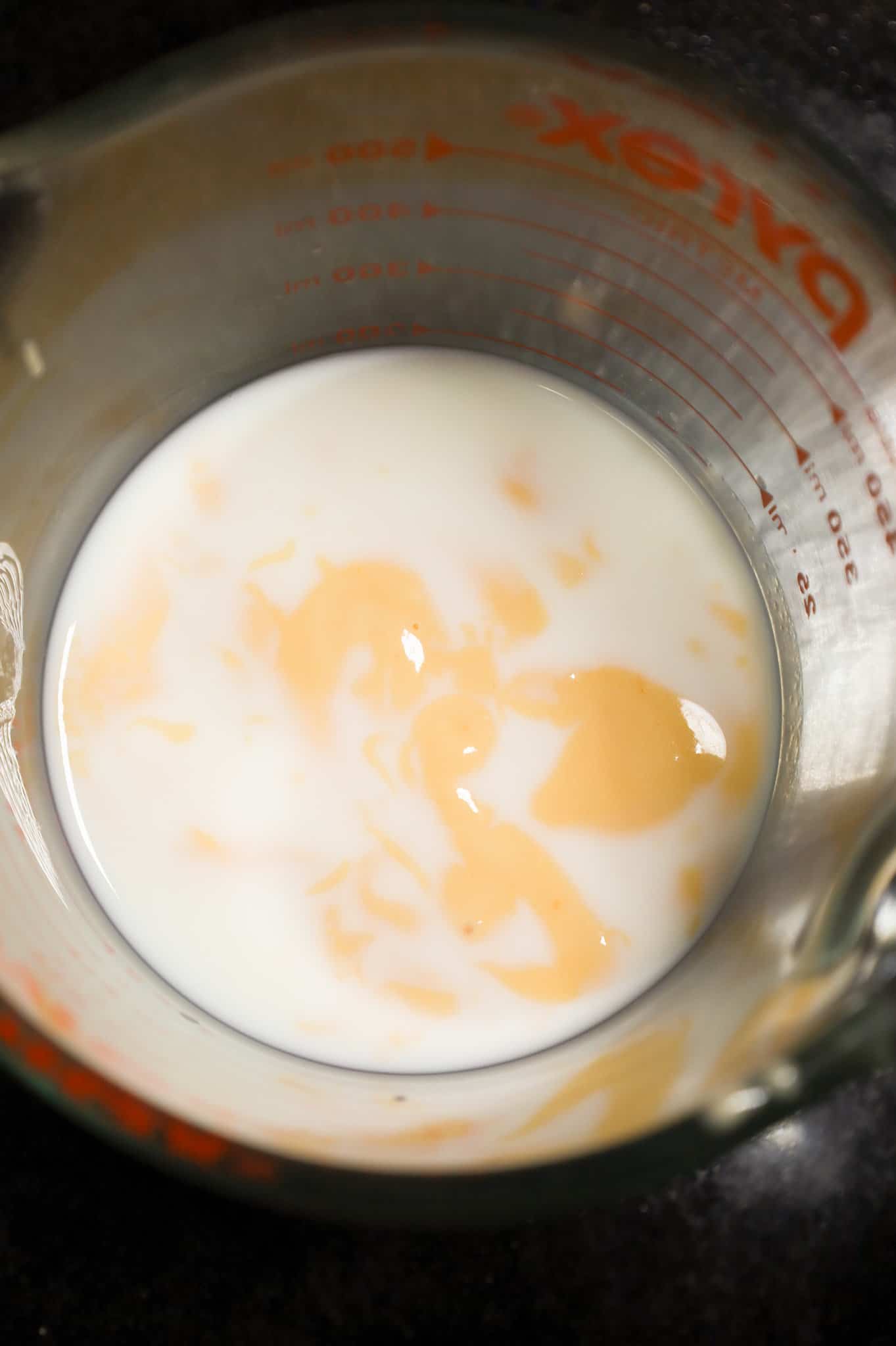 milk and cheddar cheese soup in a glass measuring cup