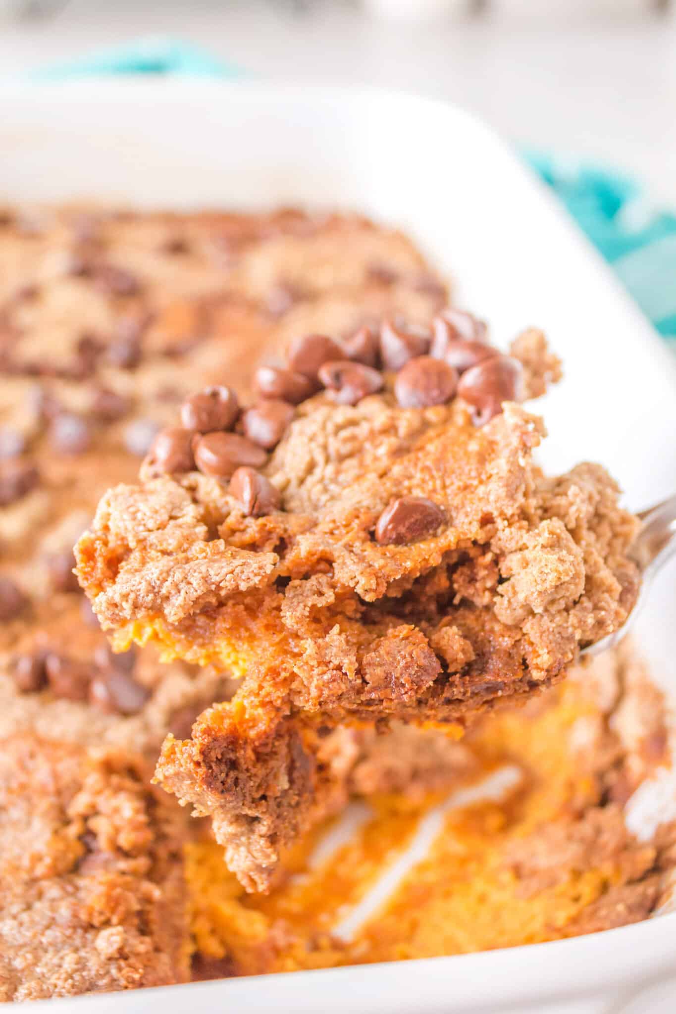 Pumpkin Dump Cake is an easy dessert recipe using canned pumpkin puree, sweetened condensed milk, boxed spice cake mix and milk chocolate chips.