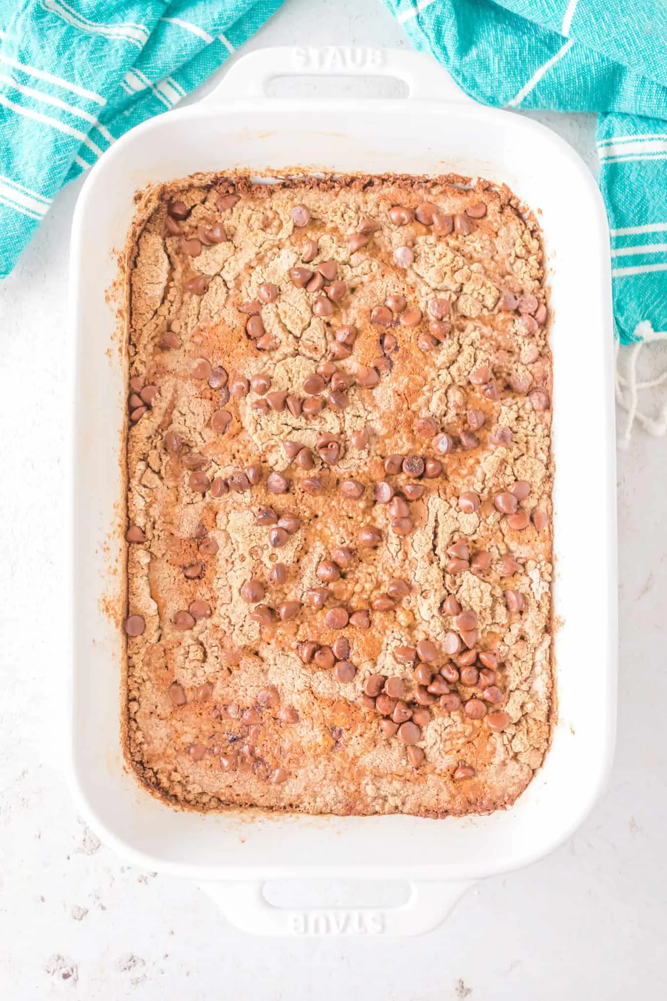 Pumpkin Dump Cake is an easy dessert recipe using canned pumpkin puree, sweetened condensed milk, boxed spice cake mix and milk chocolate chips.