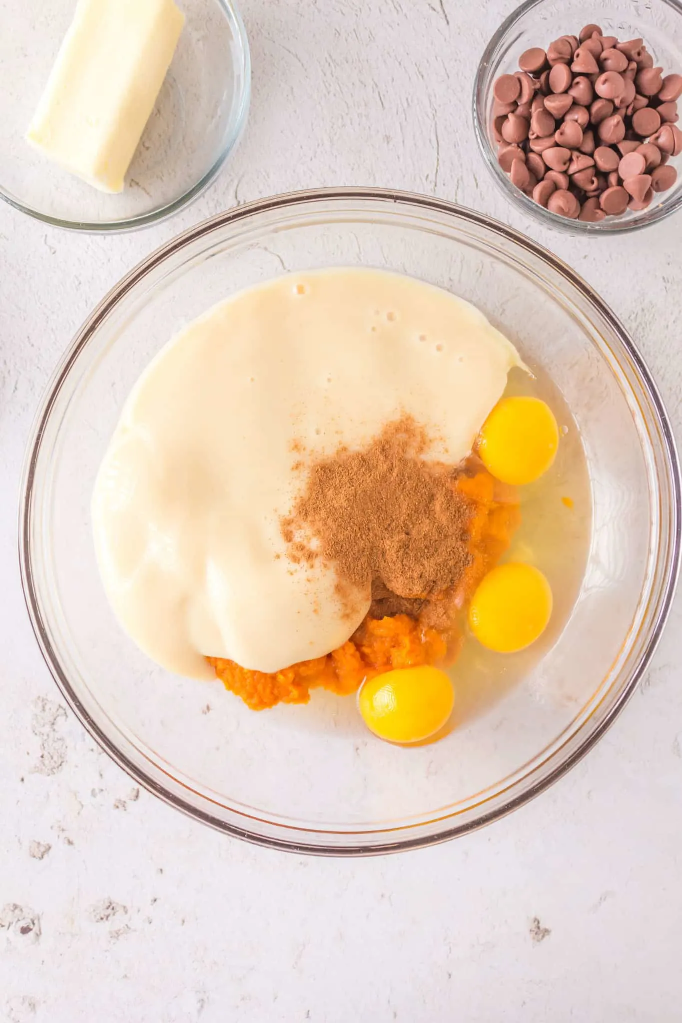 sweetened condensed milk, eggs, pumpkin spice and pumpkin puree in a mixing bowl