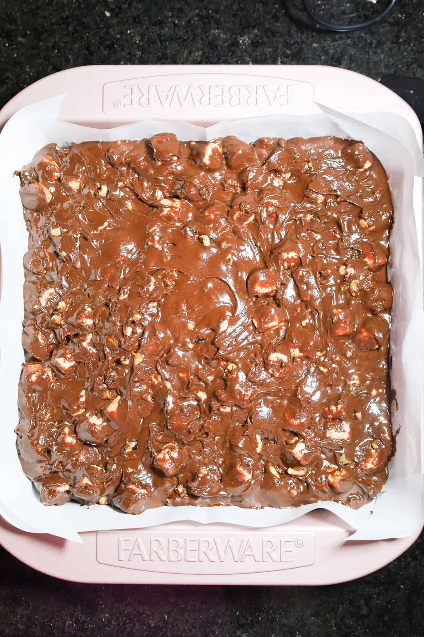 rocky road fudge mixture poured into parchment lined baking dish